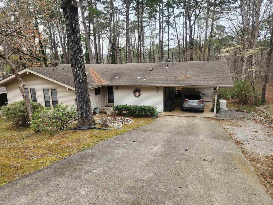 Welcome home to this three bedroom one and half bath home located convenient to the West gate and all the area amenities. Large windows will greet you bringing in the natural beauty of the Village. Great working kitchen with lots of counter space. Generous bedroom sizes. Cozy up to the propane stove in great room in our cooler months. Lots of storage both inside and outside the home in the generous storage closet in the carport. Full house Generator, No need to do anything home is ready to be occupied