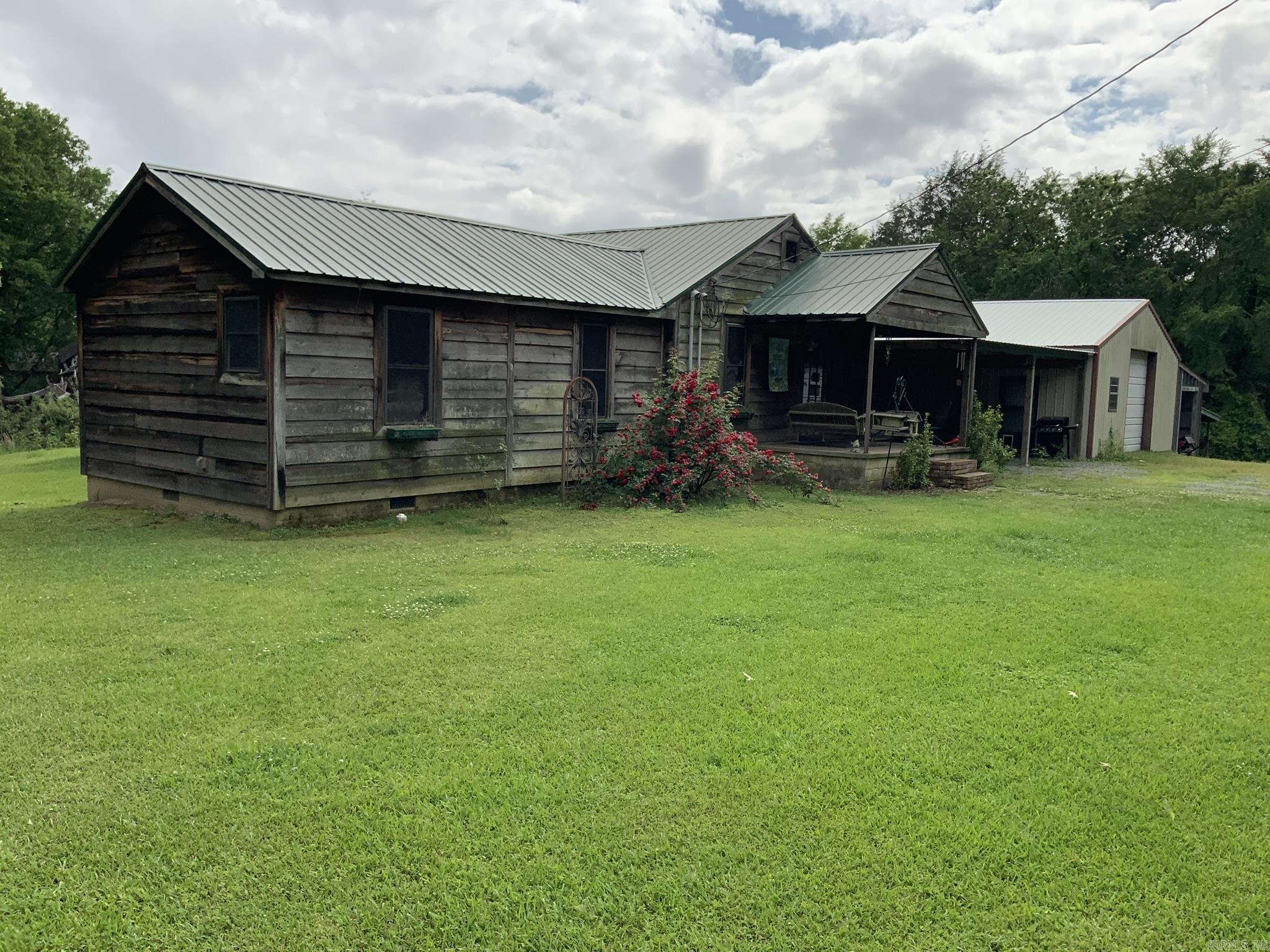 Country home sits on 40 acres: This country home has 3 bedrooms,2 baths 1656 sf. Updates to include tongue and groove ceiling and walls throughout the home, laminate flooring and tile in the baths updates approx. 6 years ago. There is a covered deck. New metal roof approx. 6 years old. Nice shop approx. 30x40 with electricity and a full bath. Great property for deer hunters. Also close to the White River for fishing or duck hunting. Property is SOLD AS IS. (Also to include 6 additional parcels ) All parcels to be sold together, seller will not sell parcels separately.) See confidential remarks for additional parcels. ** Acreage is approx. until a survey is conducted.**