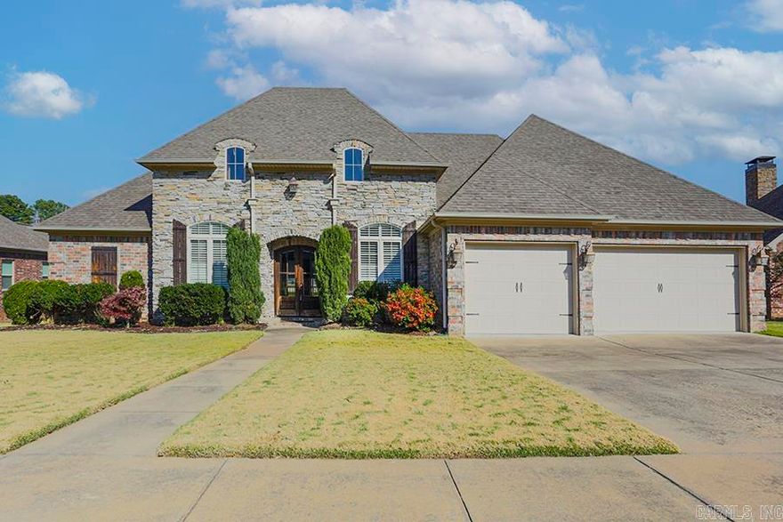 This stately stone and brick home is nestled on a quiet Cul de sac in the prestigious Overbrook neighborhood of Sherwood. This home boasts a blend of elegance and comfort. As you enter the doubled arched doors into the inviting foyer you are flanked by a comfy den/office on one side and the grand dining room on the other - both with plantation shutters. Through the doorway you will enter the heart of the home which is the large great room with gleaming hardwood floors, bright wall of windows, stunning coffered ceiling and a warm stone fireplace complemented by built ins. The kitchen is a chef's dream featuring granite countertops and tumbled stone tile backsplash. A large island, gas cooktop/stove, refrigerator and microwave convey and there is also a spacious walk-in pantry. The primary BR is extra-large with a wonderful bath with tub and walk in shower plus a large walk-in closet. Two other bedroom suites round out the main floor with a half bath and laundry room. A bonus room awaits upstairs for storage, game room, home theater, etc. A partially covered back deck and roomy three car garage with built in cabinets for ample storage completes this beautiful home. Come see!