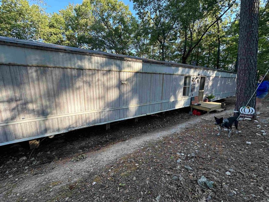 Looking for a little country freedom? This recently remodeled mobile home sits on 3.73 unrestricted acres just outside of town and only a short drive to Bull Shoals Lake. Inside, the home has been updated within the past two years, offering fresh finishes and a comfortable place to settle in. A newer septic system is already in place, and while a well is still needed, water is easily accessible through the local spring system. With no restrictions, you’ll have the flexibility to make the property truly your own—whether that means gardening, a few animals, or building out additional space. Enjoy peaceful country living while staying close to town conveniences and lake life recreation.