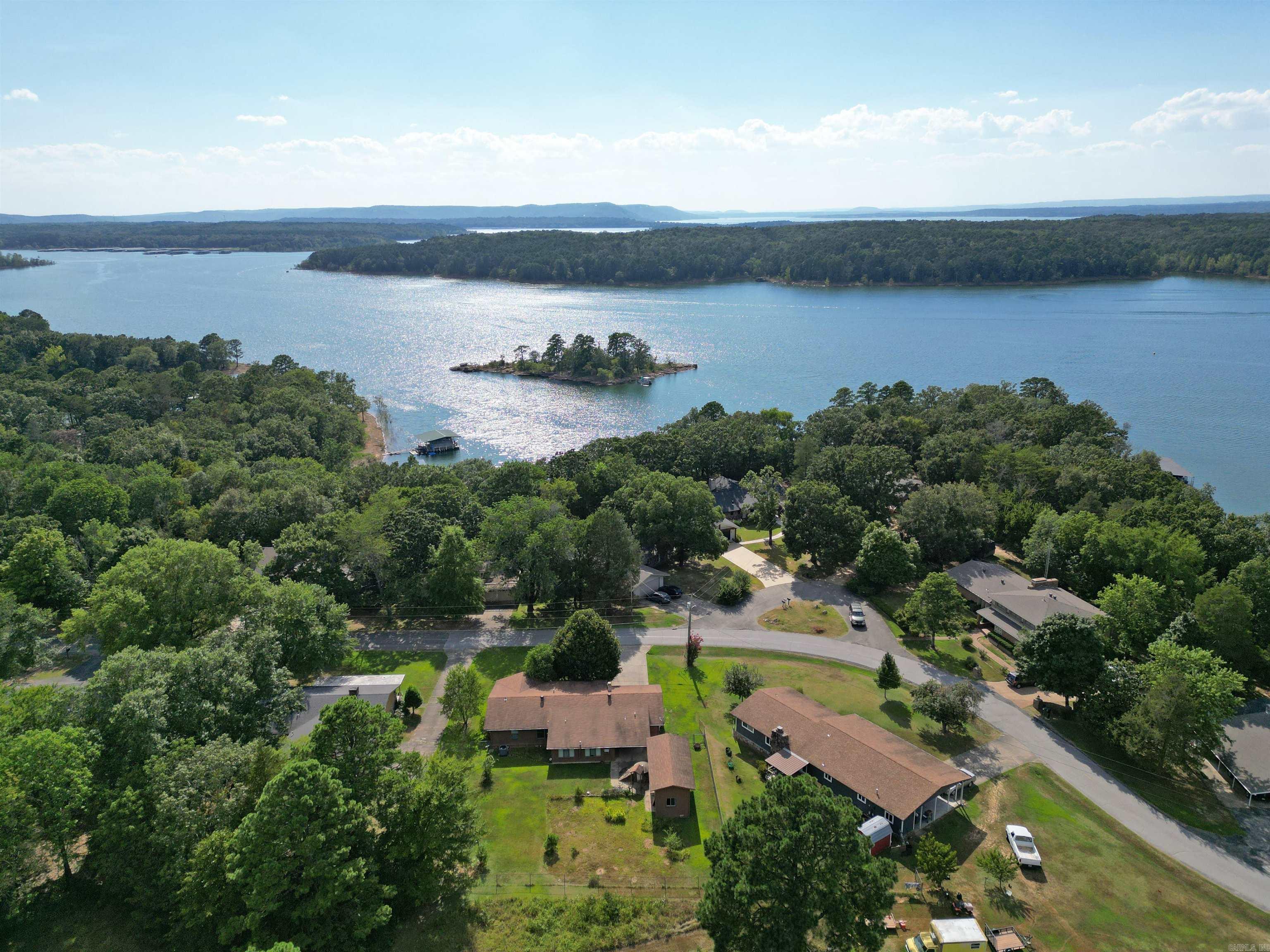 Desired location just across the street from Greers Ferry Lake plus Heber Springs shopping and dining minutes away. This fixer upper needs some TLC to bring it up to date again. Open Living/Kitcken area with vaulted ceilings & gas log fireplace. 3 BR, 2 BA. Master w/private BA and walk-in closet. Plenty of storage & seperate laundry RM. Sunroom heated & cooled over looking the fenced backyard, covered patio, storm cellar and 7 x 10 storge/shop building. Thunderbird Country Club and Damsite Recreation Area/Marina a few short miles away.