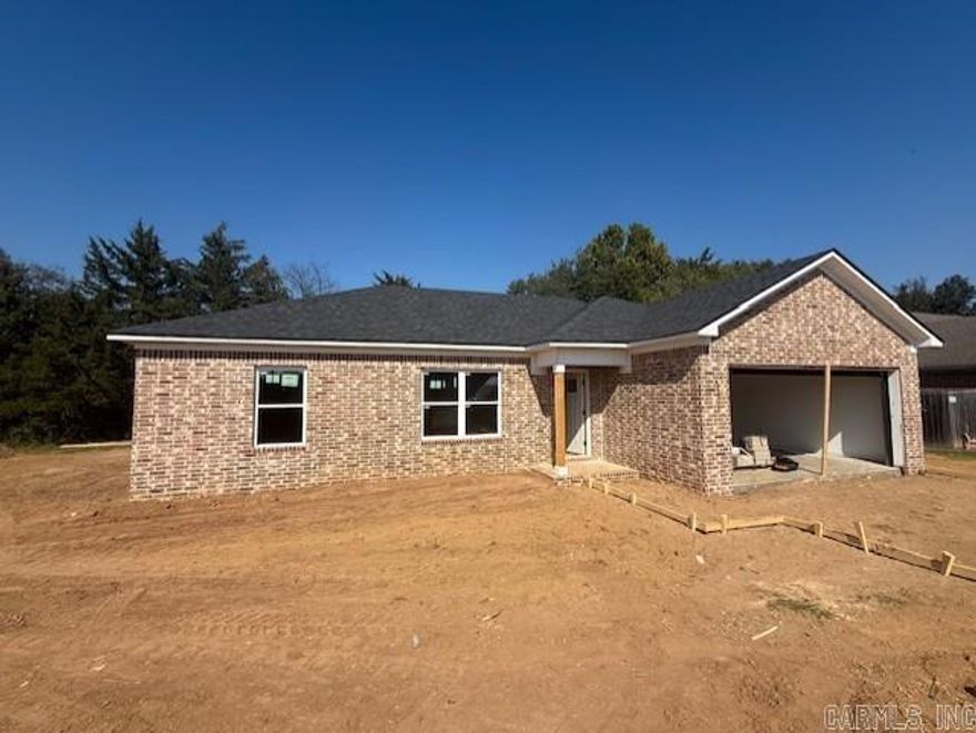 Stunning new construction home in Morrilton's Parkway Estates. Beautiful brick exterior with 2 car garage. 3 bed/2 bath home with granite countertops, tray ceiling in living room, and a spacious primary suite. Split floor plan with primary suite apart from other bedrooms. Extra room in the front bedroom corner for a desk that would make for the perfect office.  Energy efficient windows, low maintenance stained concrete floors, and architectural shingles are just some of the many features that make this home a sound purchase. The back yard has a row of trees that lend to privacy and create a green space during the warm months. Great location with Morrilton schools, UACCM, and downtown Morrilton all within 5 minutes or less. If you work in Little Rock or Conway but don't want to pay the prices to live in those areas, this is a great option! Easy access to I-40. This is a great price for a brand-new home! Tax estimate is based off of vacant land. Why pay high rent, when you can buy a new construction home?! Contact your lender to see if you qualify for a $0 down loan on this home! Agents, see remarks.