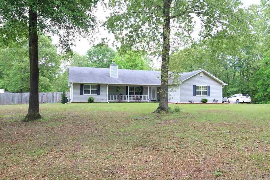 Remarkable move in ready home resting on 3 acres!  Spacious floor plan with kitchen open to living and dining room.  Beautiful hardwood floors and gas burning fireplace in the living area.  Kitchen features a breakfast bar, eat in area with bay windows and large pantry.  Split floor plan with oversized master suite with nice size closet and walk in shower and tub with double vanity.  Serene backyard fully fenced with dog run overlooking wooded area.  Oversized deck with natural gas grill.  Security system