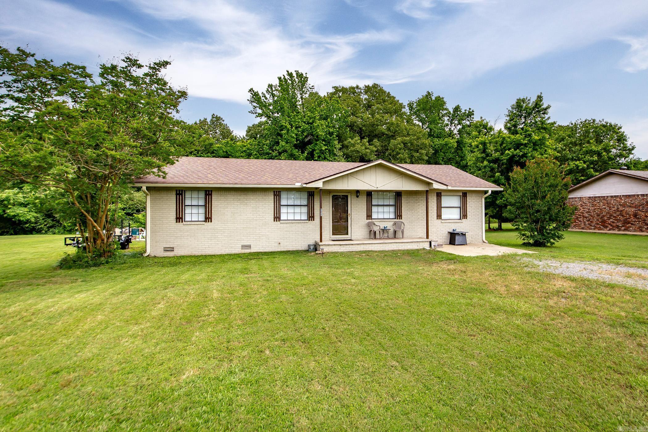 This beautifully updated 4 bed, 2 bath home sits on nearly an acre and offers space, style, and comfort both inside and out. The large living room is perfect for gathering, while the kitchen features granite countertops, a tile backsplash, stainless steel appliances, and a moveable island for added versatility. Spacious bedrooms include a primary suite with a private half bath. Step outside to an incredible backyard retreat with a fenced area, deck, patio, firepit, and a serene wooded backdrop—ideal for relaxing or entertaining.