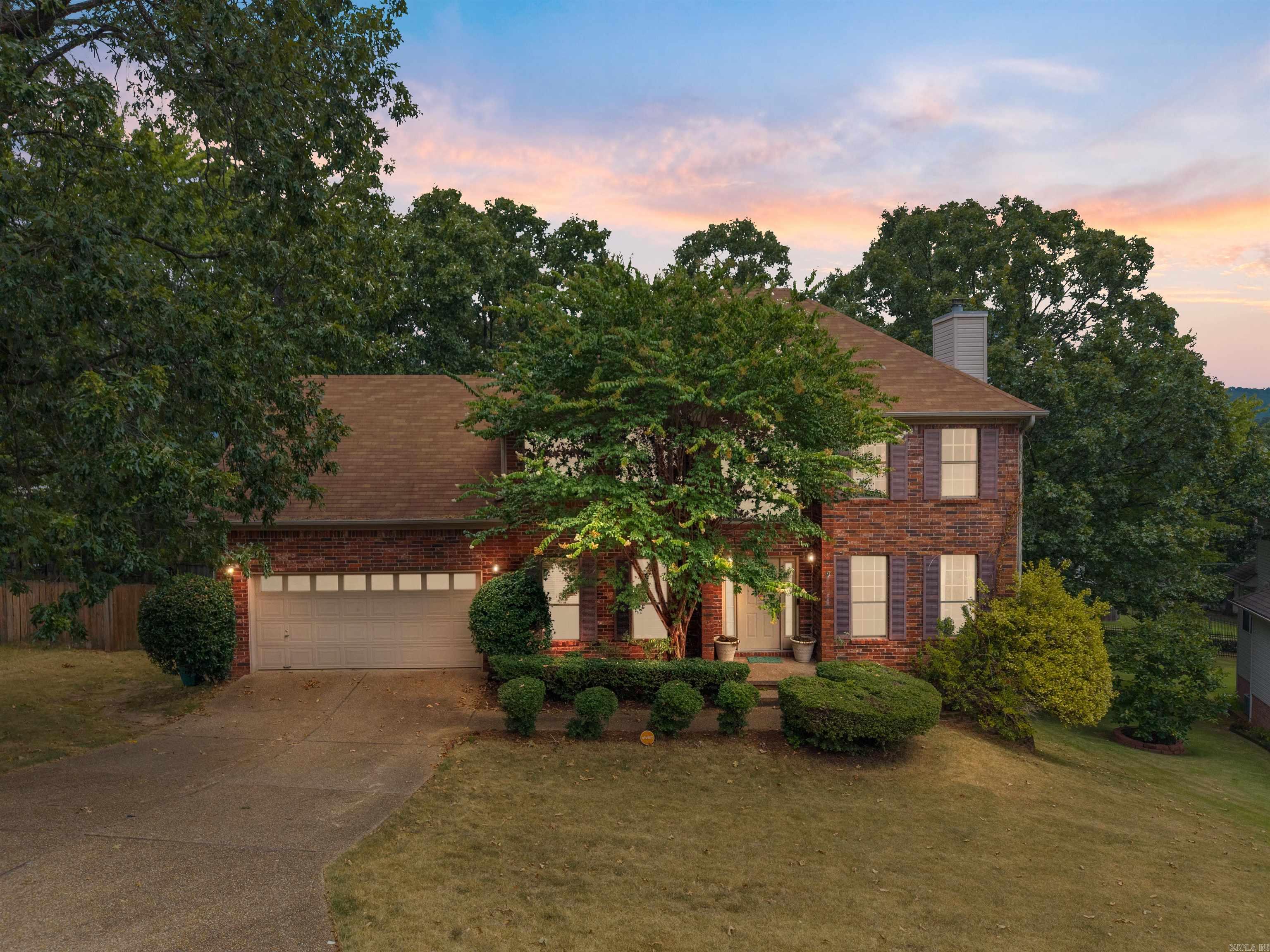 Charming two-story home located at the end of a quiet cul-de-sac in the desirable Charleston Heights neighborhood in West Little Rock. This centrally located home is zoned for the top-rated Little Rock public schools, easy access to nearby shopping and dining. The classic brick exterior and inviting curb appeal welcome you into a light-filled interior featuring new luxury vinyl plank flooring throughout most of the home. The two-story foyer opens to a formal dining room and spacious great room with a cozy gas-log fireplace and backyard views. The kitchen includes a prep island, electric range, microwave, dishwasher (2022), and a negotiable refrigerator (2024). A sunny breakfast nook provides the perfect spot for casual dining, and a convenient half bath is ideal for guests. Upstairs, the primary suite offers a sitting area or office, walk-in closet, and en-suite bathroom with dual vanities, a jetted tub, and walk-in shower. Two additional bedrooms share a hall bathroom. Additional features include a laundry/mudroom, two-car garage, security system, fenced backyard, and deck. A new roof will be installed after closing by the seller, offering peace of mind for the new homeowner.
