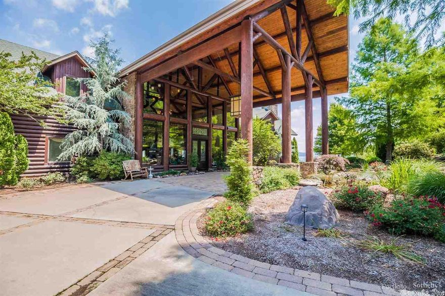 Step into this luxurious, Greers Ferry Lake retreat, artistically crafted log home, and nourish your mind, body and spirit. Offering endless possibilities, this fully furnished estate features a gourmet kitchen, a 40’ vaulted wood-beam great room with a stacked stone fireplace, open dining room, a recreation room with wet bar, an exercise room, 12 bedrooms – each with their own bath or access to shared bath and all with private views of the lake– plus a detached 3-car garage area with 2 separate apartments.