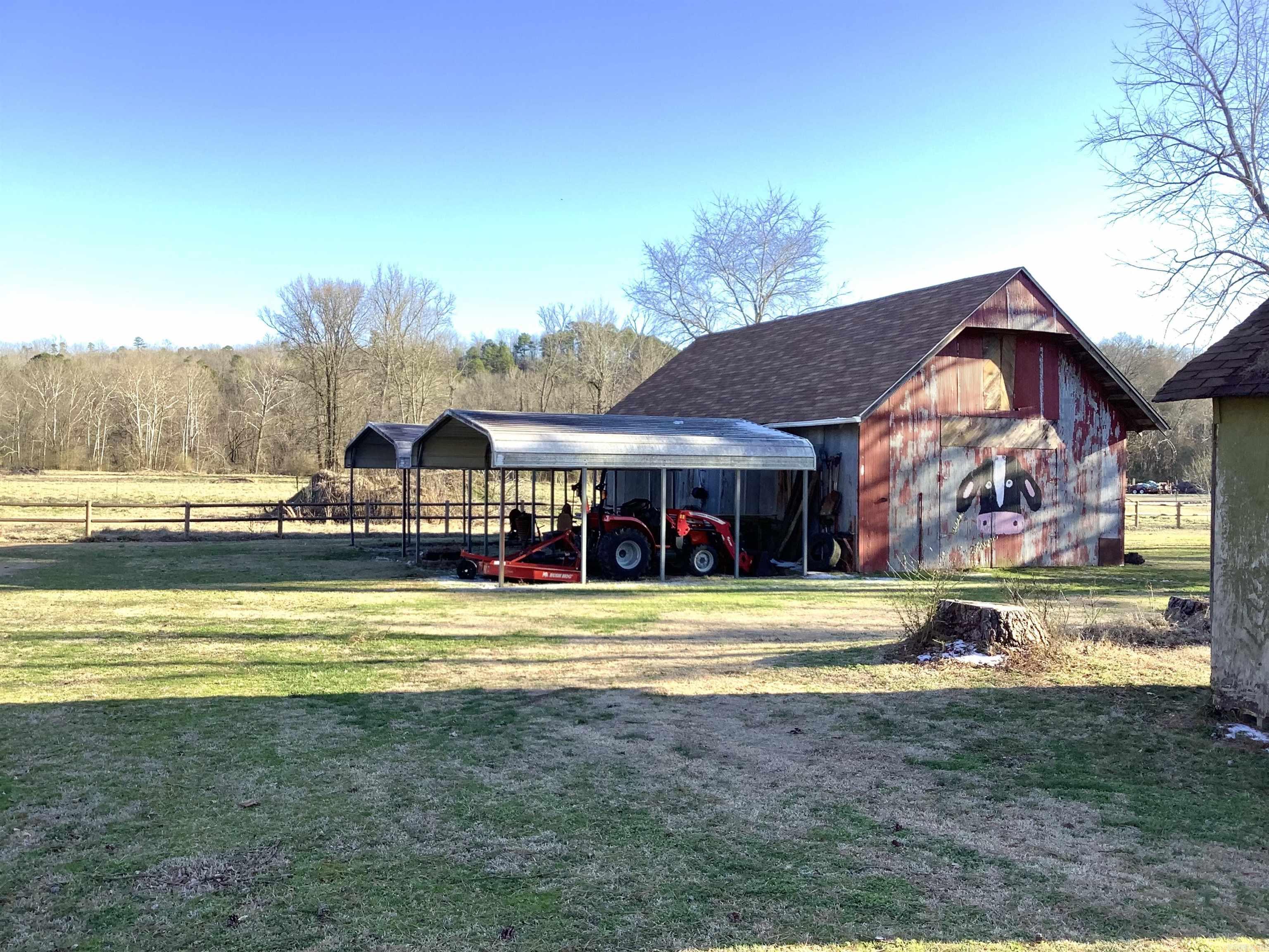Fountain Lake School District on 1.02 acres, with barn/workshop, covered RV parking, +more. This home has a spacious living room with vaulted ceiling and gas log fireplace. Kitchen and dining area with plenty of cabinets and gas range. The basement has a tall ceiling with interior and exterior entry that offers a versatile area that could be used for storage, crafts, or converted into extra living space. Large covered back deck overlooks the lush yard surrounding the home and the barn adds a touch of rustic charm. Outside city limits. New roof on barn December 2024.