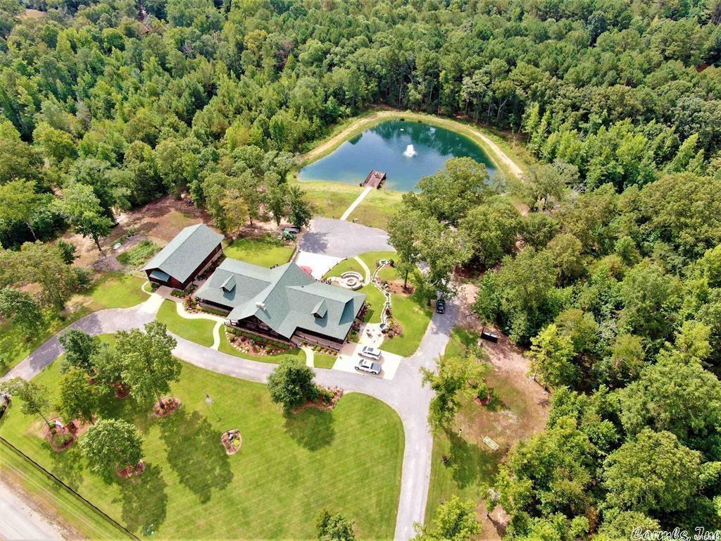 Ever wanted your very own Resort? Ranch? Special Getaway? Dream Home? Here is your best chance to have it ALL! Custom Designed Log Home with TOP of the line Everything...you must see it to believe it! Only 2 miles from Lake DeGray, 21 acres comes with a POND! Floors are hand-scraped Hickory, knotty pine ceilings direct from Colorado, Alder wood doors, Aspen wood cabinets. Full Stone Masonry Fireplace vented to heat the house. Thermador appliances, warming drawer, bar fridge, ice maker, quartzite counters,