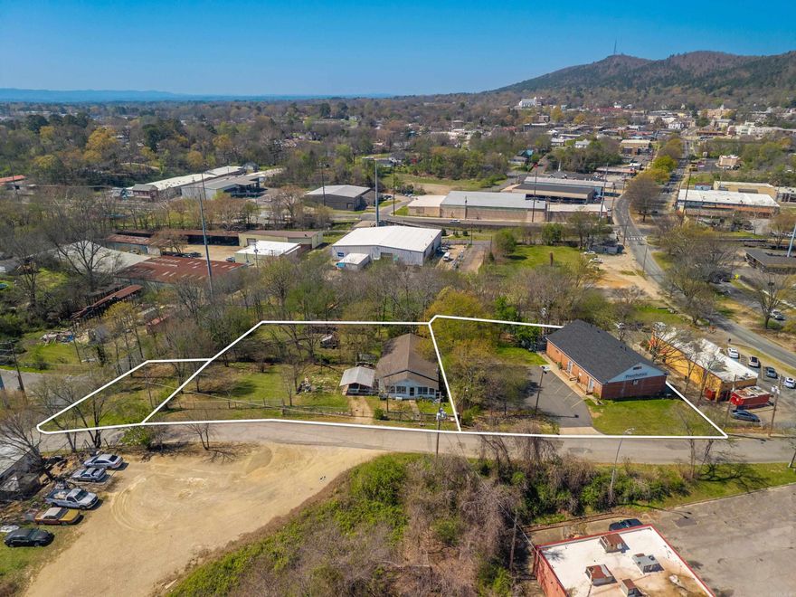 1.22 acres in the city limits! 3 PRIME PARCELS available near downtown Hot Springs - all ZONED COMMERCIAL.Adjacent to the Gateway Reviltilization Project on Malvern Ave, and one block from the the Greenway Trail along Hot Springs Creek.  Perfect for redevelopment or immediate use, this property includes an existing office building, a house, and a vacant lot offering flexibility for investors, businesses, or mixed-use projects. Ideal for office, retail, or hospitality development. 120 Hill street Suites A & B was built in 1975 and the roof was replaced in 2024. Suite A currently houses Mobility Prosthetics which has a 2 year lease. Suite B is an office/apartment with full bathroom & kitchen.  124 Hill St is a 1280 sq ft home built in 1938 but updated and has a new HVAC. Current tenant is month-to-month