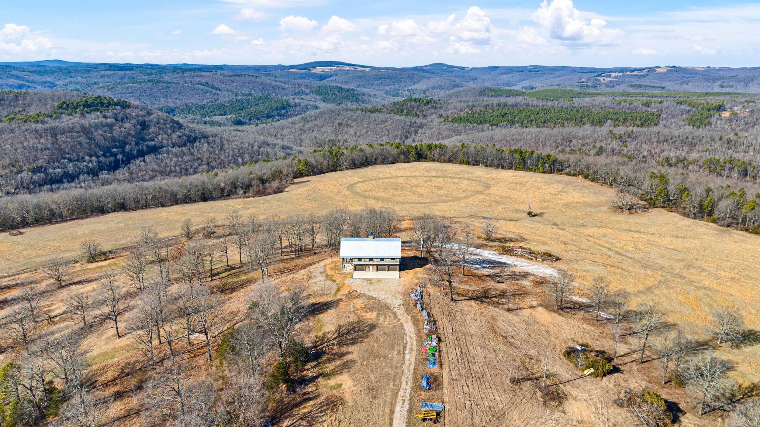 This is a once in a lifetime opportunity! The Snowlick Mountain Ranch includes 317.78 Acres and Panoramic views for miles. With roughly 100 Acres of manicured fields, 4 ponds and the remaining prime hunting ground with napier creek running along the southern border. This tract was previously a high fence ranch with miles of 8 foot fence still remaining. The Brand New Custom built (Timber Frame) Cabin is like something you'll only see from a magazine. Every Log, board and Peg that built this Cabin was harvested from this property, it's so incredible to see the craftsmanship and perfection that went into this build. The Cabin is 5,600 Sqft Heated and Cooled with the garage area included. Upstairs in the main living area is 2,800 Sqft 2 Bedrooms and 3 Full bathrooms. THIS WILL NOT LAST LONG!