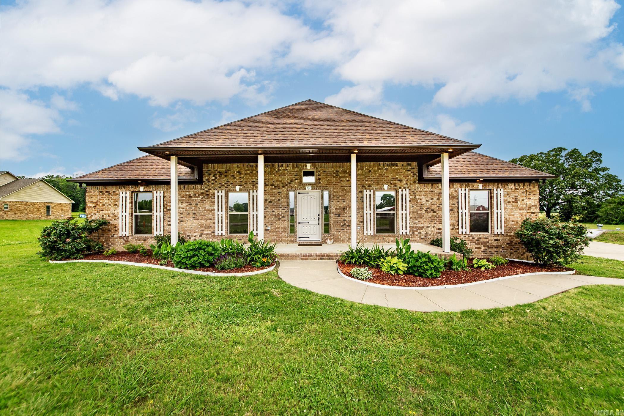 Meticulously maintained home on 3 acres surrounded by a peaceful country setting. Front Porch Charm & gorgeous landscaping greets you as you step into the formal entry way. Home features high ceilings, lots of natural light & beautifully stained concrete floors. Kitchen has tons of cabinet space, granite countertops, SS appl, large pantry, breakfast bar & seamless view into the living room w/fireplace adding warmth & coziness. Crown molding & uplighting provide an elegant touch. Formal dining room or flex space. Home offers a split floor plan that ensures privacy, w/primary suite serving as a true retreat. It features soaker tub, a standup shower, a double vanity, private water closet & walk in closet. Utility room is oversized & accessible from mult areas including master closet. Sit on the front porch & enjoy view of horses just across the street! Green space behind! Storm shelter just steps from back door, oversized 800 sq foot detached garage, luxury chicken coop (ventilation doors, exhaust fans & automatic doors) add'l shop w/electric! Home has ground mounted Solar ~easy for maintenance that will be paid off at closing w/acceptable offer. Close to Conway~back gate of LRAFB!