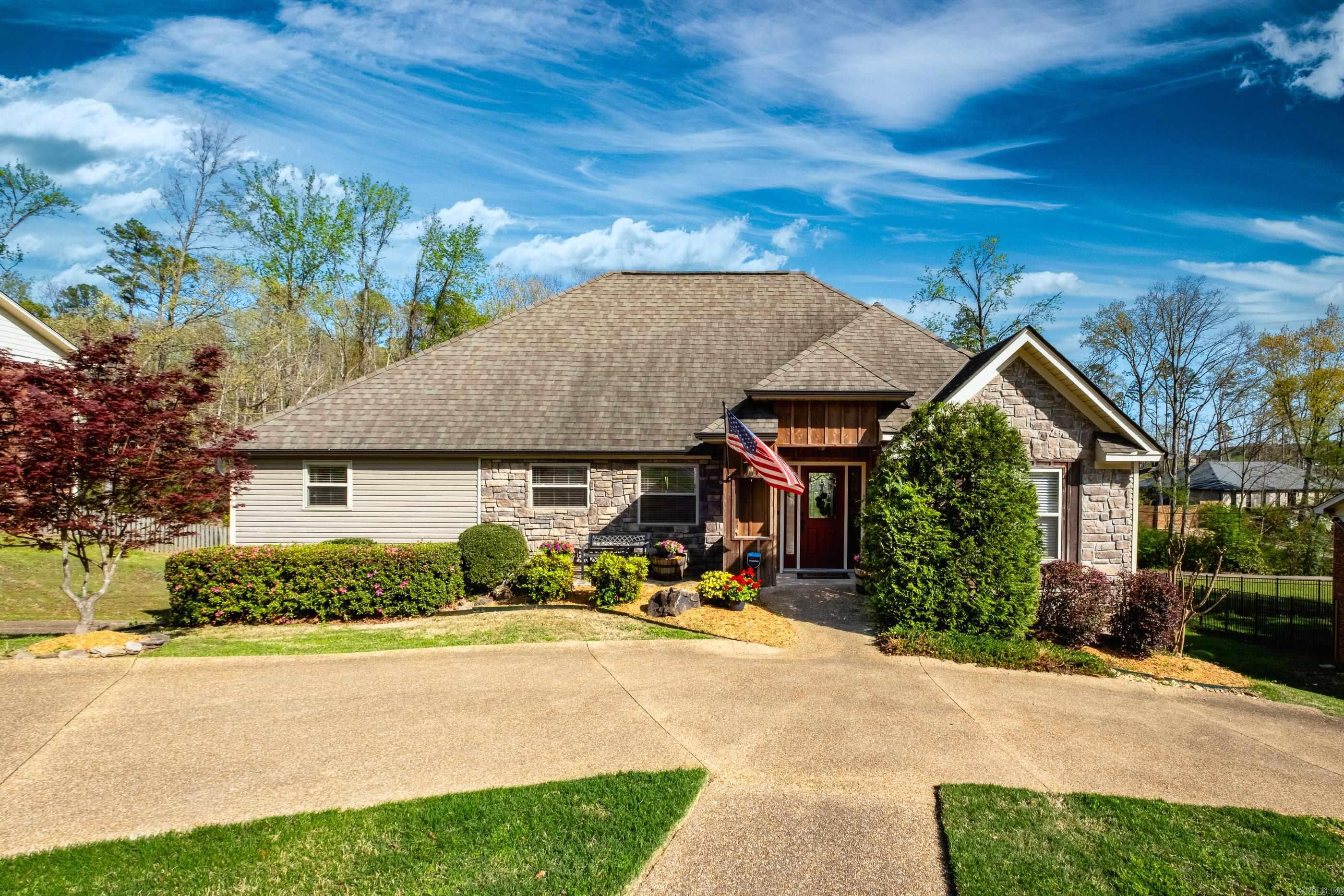 Charming open concept home with a stunning, oversized kitchen featuring custom cabinetry, two large islands (one with seating), and wood floors in the main level living areas. The spacious dining area flows into the vaulted great room with a gas log fireplace and abundant natural light. A second sitting area off the great room offers additional space for relaxing or entertaining. Multi-level back decks overlook the backyard and green space with a walking trail, perfect for enjoying the outdoors. The main level primary suite features a generous bath and walk in closet, plus a half bath and large laundry room for convenience. The lower level includes a cozy den with a fireplace, two bedrooms, a full bath, an office area, and a flexible space currently used as a gym. Carpet in all bedrooms, with carpet and tile on the lower level. Plenty of parking with a circular front drive, a two-car garage, and a whole house generator. Come see!