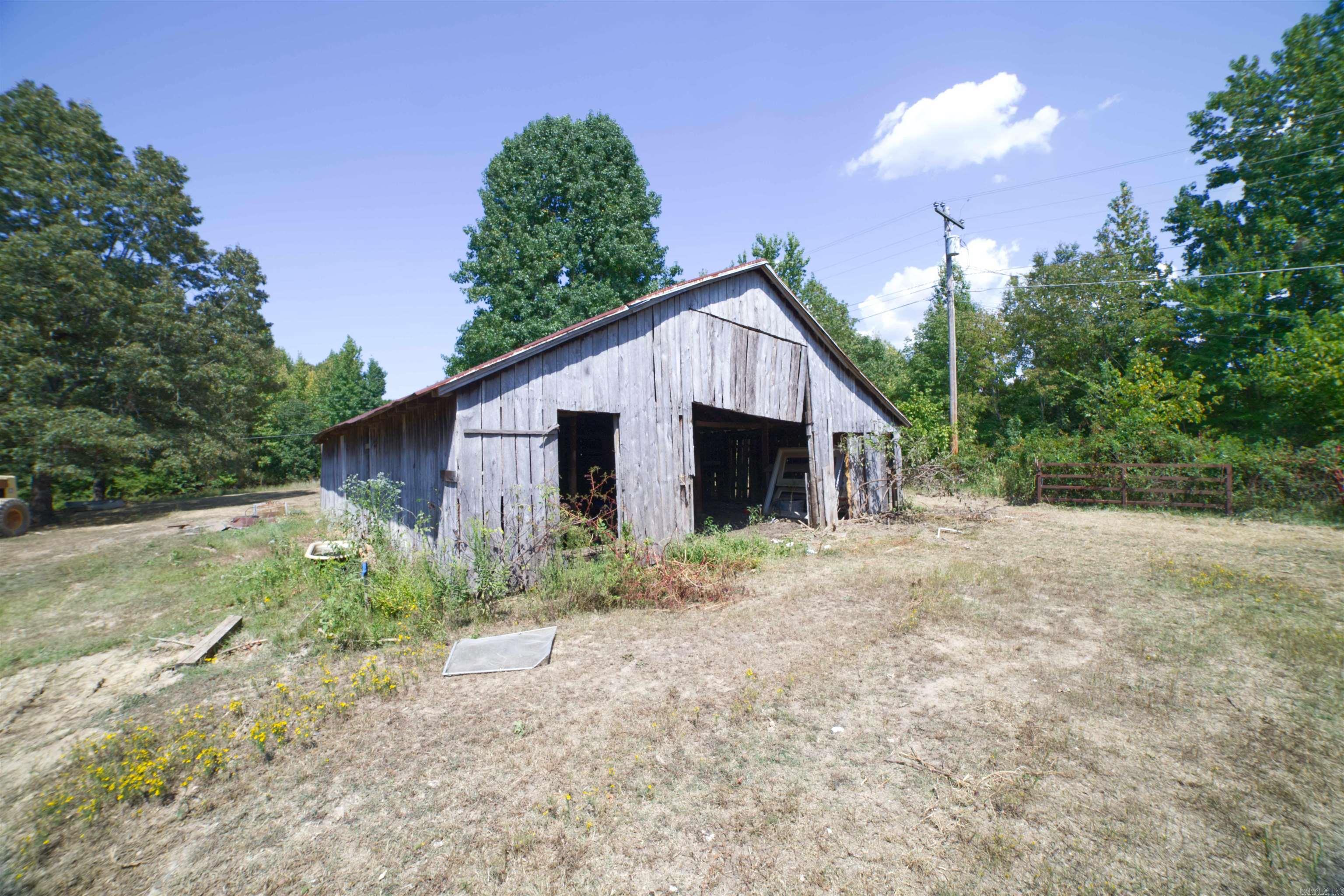 Are you looking for a peaceful spot of land to build your dream home? This is it! Just far enough out of the city, but not too far. Plenty of Dollar generals near by! Here is 5 acres of land with clearings to build, timber to stroll. There is a barn on the property and some old barb wire fencing surrounding the property. There is plenty of road frontage and it is paved! This property used to have a trailer on it and it has a septic tank and utilities on property. There is not a current survey! Lafe water and Craighead electric.