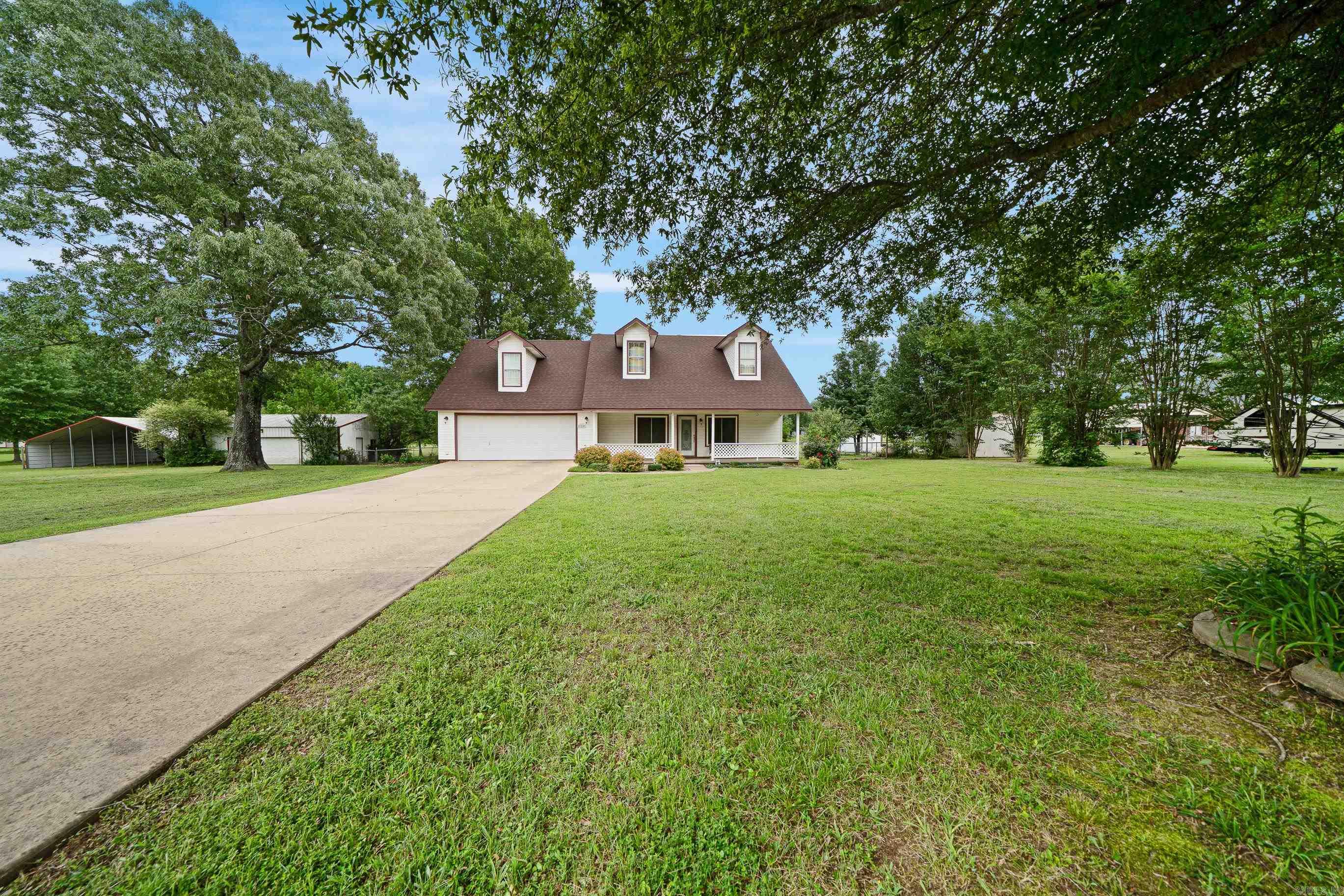 Welcome to your peaceful slice of paradise! This charming country retreat is nestled on three beautifully maintained acres. Inside, you will be thrilled to find special features such as a gas fireplace, a dedicated mud room, a built in safe, storm shelter and whole- home generator to keep you safe and powered year- round. Step outside to experience the true magic of this property - a large sunroom, a massive 30x40 shop, an RV overhang and quaint picnic tables perfect for family gatherings. Lovingly maintained by its long- term owner, this home is move in ready and waiting for its next chapter. Whether you're looking for room to grow, space to play, or a place to finally slow down and enjoy the good life, this home has it all.