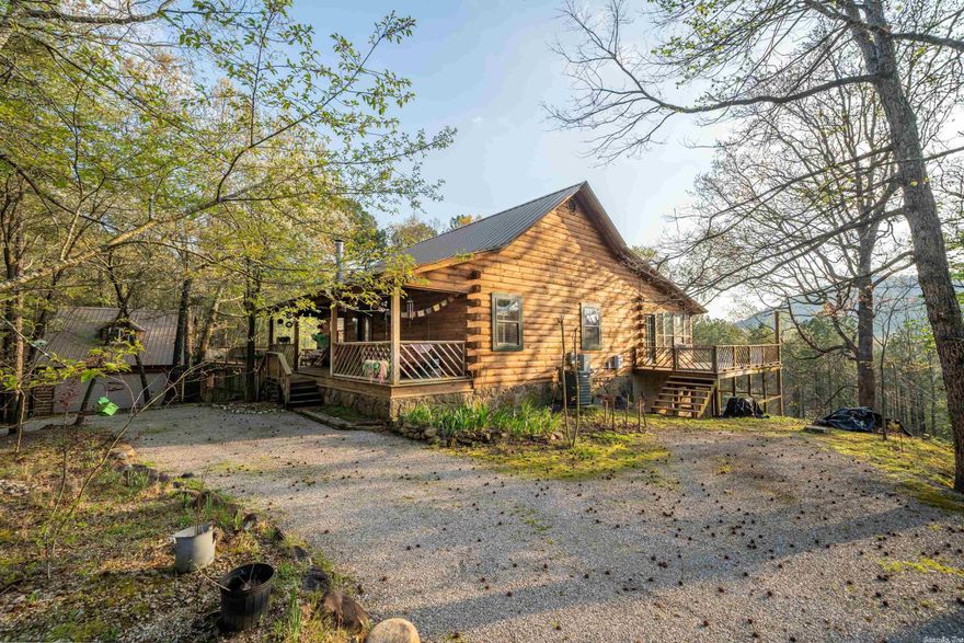 Cabin in the woods!  This beautiful rustic log home boast 3 bedrooms & 3 full baths(3663 sqft) with 1 bedroom 1 bath efficiency apartment(280 sqft) over the detached garage. Home features wood burning stove, spacious second living area, large open area downstairs for gameroom or bonus room, screened in porch downstairs, large wrap around deck for enjoying the wooded mountain view, solar panels and attic fan make the house very entergy efficient. Garage apartment is perfect for extended family or investment.