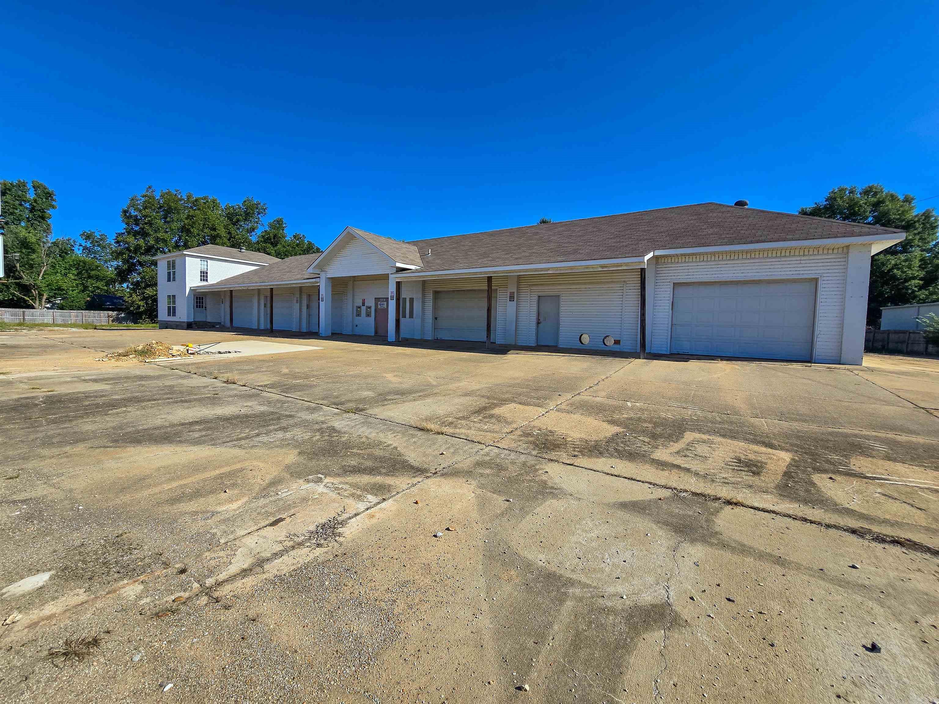 Own or lease a garage or shop and need more space? More overhead door options? Just more storage space - LOTS of storage space!? How about Office space with kitchen, full bath & rec or down-time spaces? Has that home business outgrown your home? If any of this rings true, then take a look at this property! It has tons of shop space, office space, storage space, yard space, concrete parking space...just lots of spaces with 6 overhead doors. In a great location for your busy business! Owner has a valid Arkansas Real Estate License and is also offering a lease on this property. Contact for details!