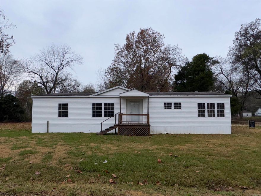 Don’t miss this incredible opportunity in the edge of Holly Grove! Spacious 3-Bed, 2-Bath Double-Wide on Multiple Lots Near Maddox Bay – Perfect for Hunters, Homeowners, or investors. This trailer is only 13-year-old and is anchored for stability, and has an attached carport An F5-rated tornado shelter for added peace of mind. Inside, the home offers three spacious bedrooms, three full bathrooms, and a large living area—plenty of room for family, guests, or entertaining. The newly updated kitchen, updated four years ago, features striking black ceramic tile counters and a modern, functional layout. NEW ROOF! This property sits on 10 lots, just 6 miles from Maddox Bay, known for its outstanding hunting and fishing. An additional adjoining lot (0.40 acres) is included, making it an excellent setup for expansion. There are water hookups on four lots, electricity available, and ample space to add additional mobile homes, cabins, or buildings. Whether you're a hunter looking for a camp near world-class wildlife, an investor seeking multiple lot potential, or someone wanting a roomy home right in the center of Holly Grove AR!