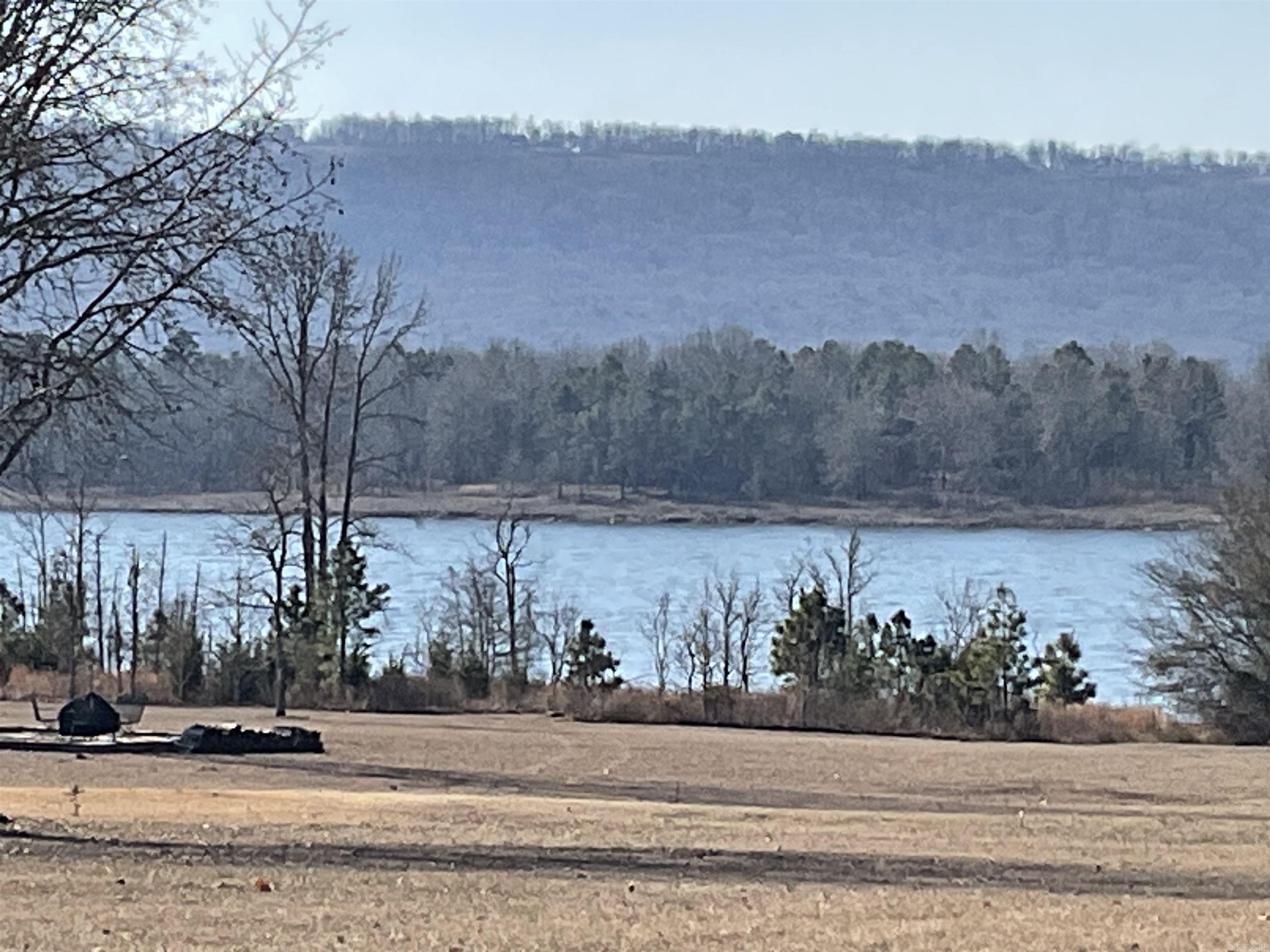 Beautiful level lakefront lot. Sit on ur deck and watch the boats go by or better yet be out there with them and just pull up to ur shoreline and walk up to the house when u are thru with ur day of fun and sun on the water. Great view of Diamond Bluff and this lot sits in between two marinas for boat storage, gas or etc. Located in prestigious Emerald Isle a gated community of Greers Ferry in the heart of town.