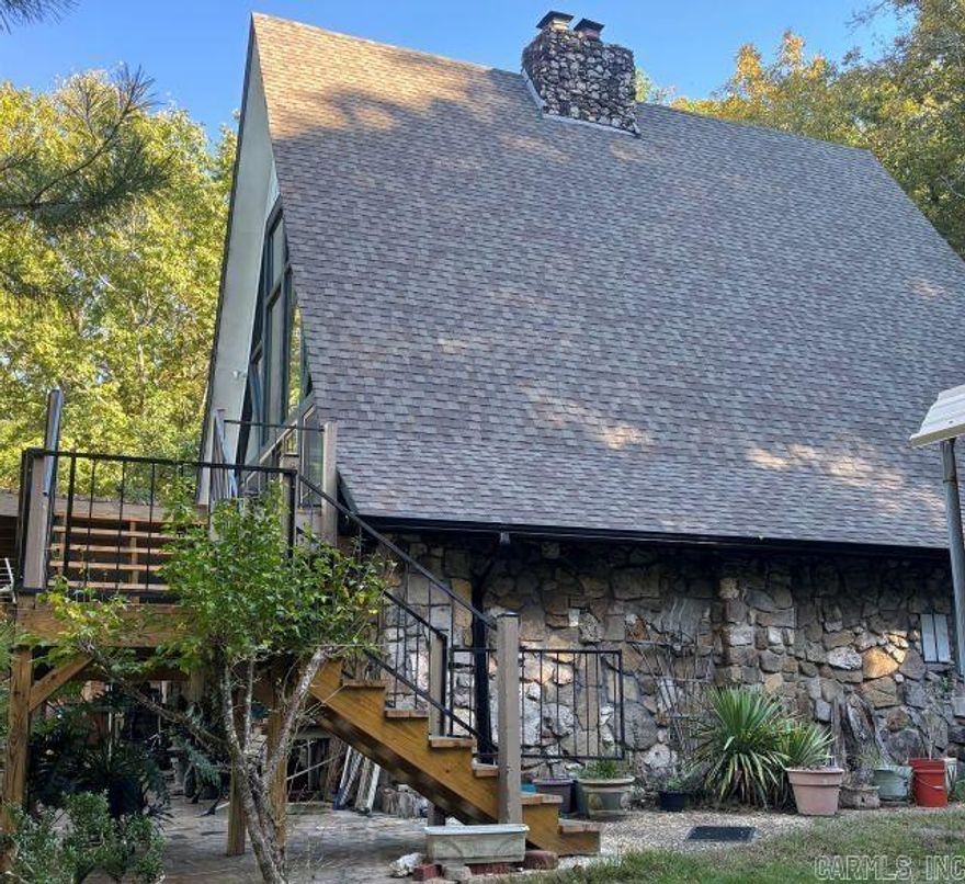 Magnificent views from this three-story A-frame with glass front and wrap around deck nestled in the woods up next to a mountain.  Features a winding drive behind a privacy gate for privacy.  Also features a 2-car garage/barn with upstairs and added on porch.