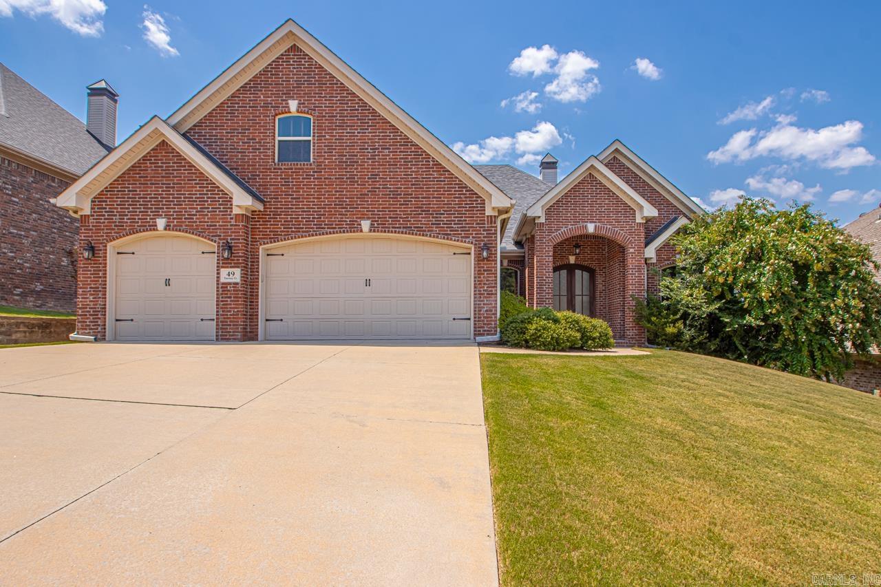 Exquisite single-owner residence featuring a gourmet kitchen equipped with premium stainless steel appliances, including double wall ovens, a dishwasher, a gas cooktop, pull-out spice racks flanking the cooktop, and abundant cabinetry for ample storage.The elegant formal dining room, located at the entry, seamlessly flows into the expansive great room, showcasing stunning hand-scraped hardwood flooring. The inviting covered back patio, complete with a fireplace, offers a retreat for relaxation after a long day.The luxurious primary suite boasts a sophisticated lighted tray ceiling. The en-suite primary bathroom features a spacious walk-in shower, a separate soaking tub, and a marble countertop with dual sinks, walk in closet. The office space, situated just off the entry, provides generous square footage and a large window for abundant natural light. The conveniently located laundry room is accessible from the garage entry. A tastefully designed half-bath is situated in the hallway. Two additional bedrooms share a stylish Jack-and-Jill bathroom. The upper level offers a versatile, expansive open space with a full bathroom, ideal for creating a retreat or entertainment area.
