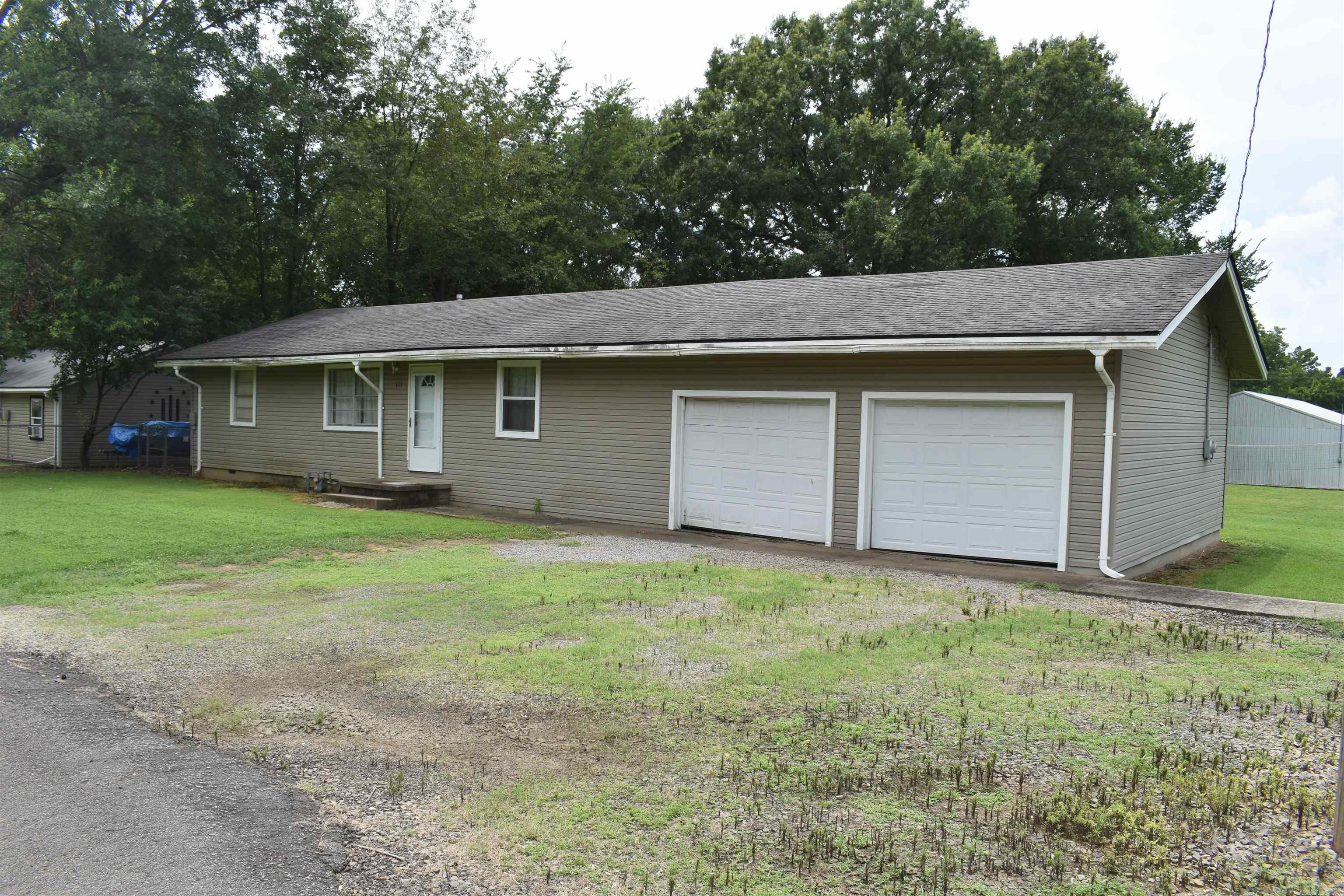 Located in the quiet community of Havana, AR, off of Taylor St, this three-bedroom two bath home is ready for its new owner. The home is approximately 1520 heated and cooled square feet, with an attached 600 +/- square foot two car garage. The living area in the center of the home has a living room, kitchen and formal dining room. One end of the home has a utility room with plenty of space for a washer and dryer, and access to the garage. On the other end of the home, youāll find all of the bedrooms and bathrooms. The home has all city utilities, including Natural gas and fiberoptic internet. Both inside and outside the home, there is space to enjoy time with family and friends. The approximately half acre lot is open and great for activities, with large oak trees on opposing corners providing abundant shade. There are great garden areas, and even two producing pear trees as well. The lot has frontage on both Taylor Street and Slay Street, and has a large gravel parking area to the side of the home.