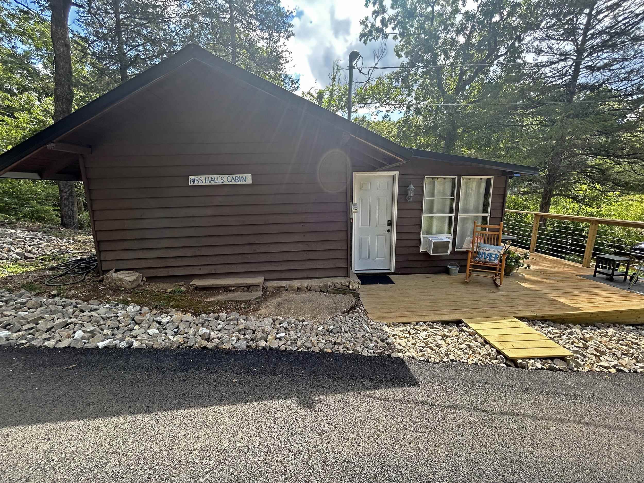 Old Camp Miramichee Cabin and 4 Creek Frontage Lots - This 577 square foot cabin is an original from girls Camp Miramichee days. The cabin has been renovated Inside, and outside with a beautiful new deck. Features include living/dining room with wood burning stove, nice kitchen, bedroom, full bath and original Flagstone flooring. Cabin is being sold furnished and is a good seasonal rental. Across the road are 4 creek frontage lots include with the cabin for an additional 3 m/l acres of land. The cabin and the 4 lots sit next to a creek that flows into the South Fork of the Spring River.