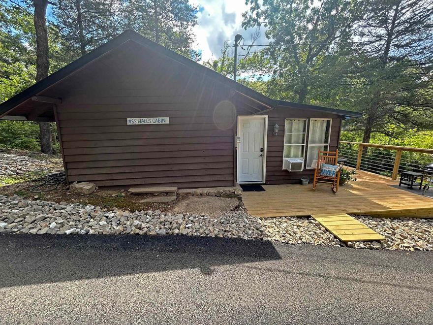 Old Camp Miramichee Cabin and 4 Creek Frontage Lots - This 577 square foot cabin is an original from girls Camp Miramichee days. The cabin has been renovated Inside, and outside with a beautiful new deck. Features include living/dining room with wood burning stove, nice kitchen, bedroom, full bath and original Flagstone flooring. Cabin is being sold furnished and is a good seasonal rental. Across the road are 4 creek frontage lots include with the cabin for an additional 3 m/l acres of land. The cabin and the 4 lots sit next to a creek that flows into the South Fork of the Spring River.