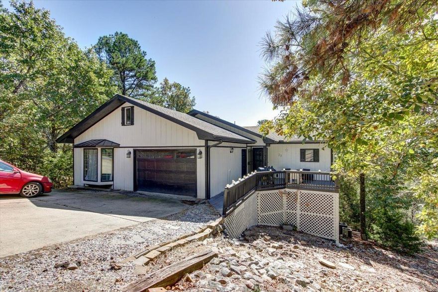 SPECTACULAR MOUNTAIN VIEW Home with Modern Upgrades  This home in the picturesque Hot Springs Village is perfectly situated near scenic golf courses and tranquil lakes. The beautifully updated 4-bedroom, 3-bath residence boasts breathtaking mountain views, best enjoyed from the newly constructed deck.  Step inside to find a recently updated kitchen equipped with modern amenities, offering an ideal space for hosting dinner parties and family gatherings. The home's fresh interior and exterior paint create a bright and inviting ambiance, while the durability of a 5-year-old roof ensures lasting peace of mind.  Experience the perfect blend of natural beauty and contemporary comfort in this charming home, surrounded by the serene landscapes of Hot Springs Village and only minutes to shopping and restaurants. With ample space for comfortable living, this property is a true retreat for those seeking both relaxation and style. Take the opportunity to make this tranquil escape your own! COME AND SEE!!   Agents - Call Showing service to schedule all showings.