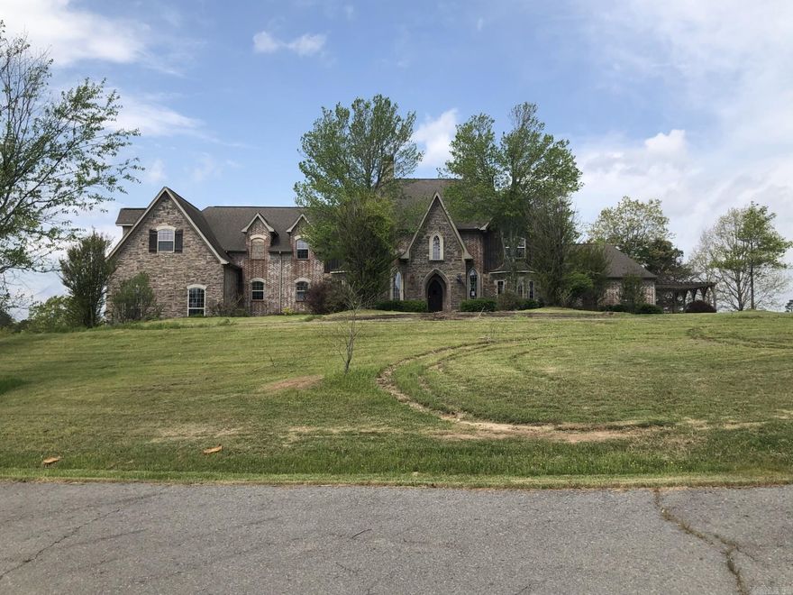 Check it out on Hubzu! This spacious property offers a unique layout. The main level features formal dining with fireplace, kitchen with butler’s pantry and walk-in pantry, two living areas—one with French doors to a full-length covered patio overlooking the inground pool, and a dual-sided fireplace shared with the second living room. A bedroom near the entry leads to the primary suite with attached flex space and deck access. Additional laundry and a 3-car garage complete the main level.  Upstairs, dual staircases lead to a central hallway, kitchenette area with water and fridge hook-ups, two bedrooms with Jack and Jill bath, two more bedrooms, two bathrooms, laundry, and a large bonus/media room with dormer window seats.  The lower level includes a bedroom with walk-in closet, plus a bonus room ideal as a pool house with fireplace, full bath with tiled shower, and a ready-to-finish kitchenette/bar area.  This home offers exceptional space and versatility for the right vision.
