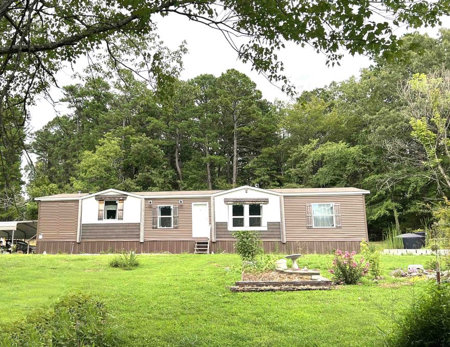 A Peaceful Retreat in the Woods – 3.48 Acres, Modern Comforts & Timeless Seclusion Discover a haven where privacy, nature, & thoughtful design come together. This  3-bed, 2-bath home sits tucked away on 3.48 wooded acres, offering tranquility & room to roam—ideal for outdoor lovers, gardeners, or anyone craving space to breathe. Step inside to 1,792 sq ft of well-planned living with an additional flex den—perfect as a home office, creative space, or optional 4th bedroom. Recent upgrades include a brand-new front landing/deck, propane wall heater for cozy winters, & a 500-gallon owned propane tank offering independence & efficiency. Outside, enjoy a detached 2-car carport, two storage buildings, & even a deer blind—a nod to the land’s natural charm & peaceful surroundings. With plenty of room for small livestock, gardening, or just enjoying the quiet, this property delivers the perfect balance of rural seclusion & modern comfort. Conveniently located between historic Mountain View & the scenic White River, this retreat offers easy access to local attractions, dining, & outdoor adventures. Shown by appointment only—come experience the quiet joy of country living.