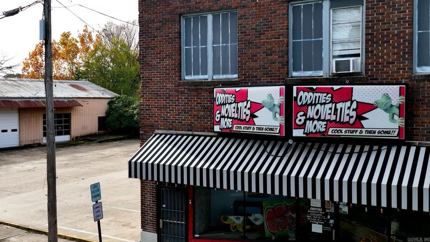 Rare opportunity to own a true piece of historic downtown El Dorado's "Hamburger Row." Formerly known as Oddities, is one of the only historic structures left on South Washington. The buildings were constructed by former Lieutenant Governor of Arkansas, Pete McCall. The entire property consist of 3 buildings (408, 406, and 404) South Washington. Above the "Oddities" building consists of 4 apartments; 3 of them are a 1 bedroom and 1 bathroom, and the 4th apartment is a full 3 bedroom and 2 bathroom with a full kitchen. Which are all currently occupied with tenants. Come check out this unique property! Property is to be sold AS-IS WHERE IS WITH ALL FAULTS.