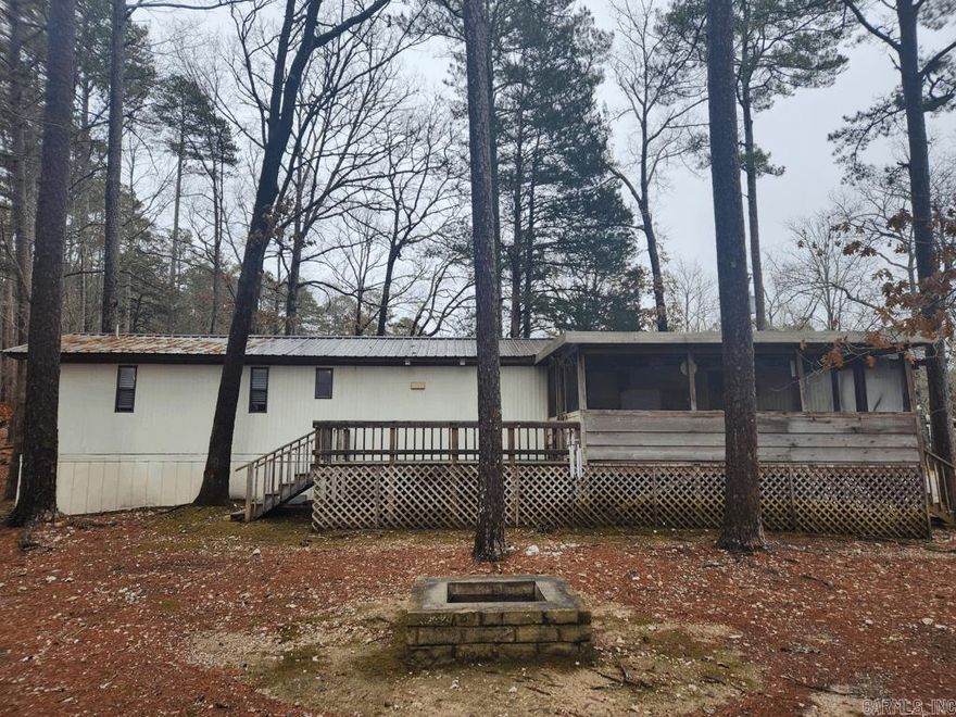 Be at Mountain Harbor Resort Mount Ida, Arkansas in a minute. This 2 Bedroom 2 Bath, 1983 model single wide mobile home in the Harbor Oaks community is ready to move in. The partial furnishings include: couch, recliner, microwave, refrigerator, dryer, dining table, and decor. There is 19X11 screened in porch and a 15X11 deck. 9X15 storage building with shelving included. Trash pick up and water are included in the lot rent. All electric and very well maintained. Tile in the kitchen and bathrooms. Beautiful tile shower in master. This is a rare find. Don't wait too long. Call for an appointment today.