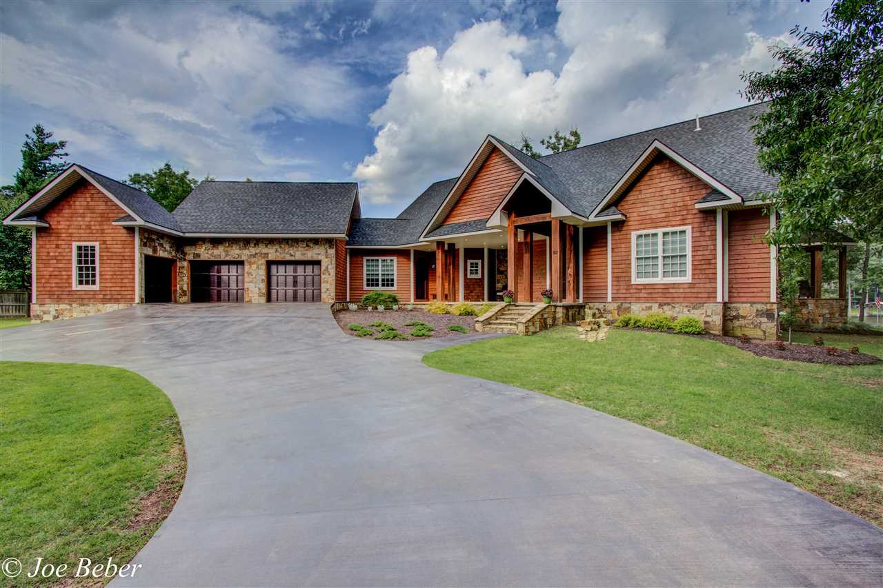 Lake living at its absolute finest! Just off the main channel this property offers breath taking views, luxury upgrades throughout, guest house, outdoor kitchen, fireplace, pool and hot tub! Your dream home awaits you!