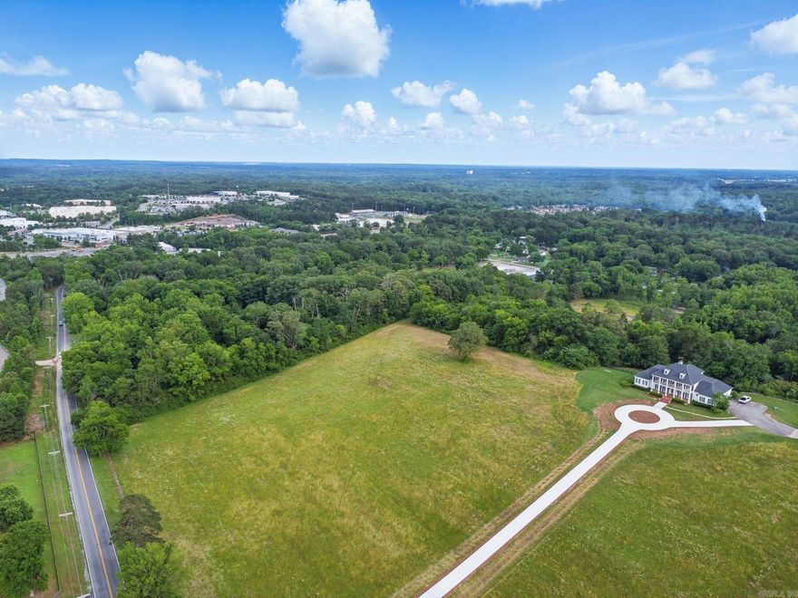 Discover Your Dream Estate in West Little Rock  Nestled on a stunning hilltop, this exceptional 10-acre homesite presents a once-in-a-lifetime opportunity to create your luxury estate in one of West Little Rock's most coveted locations. Just one mile west of the Colonel Glenn Exit on I-430, this remarkable property offers the perfect balance of secluded countryside living with unparalleled convenience to urban amenities.  From this elevated perch, you'll be captivated by panoramic views that stretch across the landscape from multiple vantage points, providing breathtaking vistas and natural beauty that will serve as the backdrop for your custom dream home.   In West Little Rock's competitive luxury market, homesites offering this unique combination of acreage, elevation, views, and location simply don't come available often.