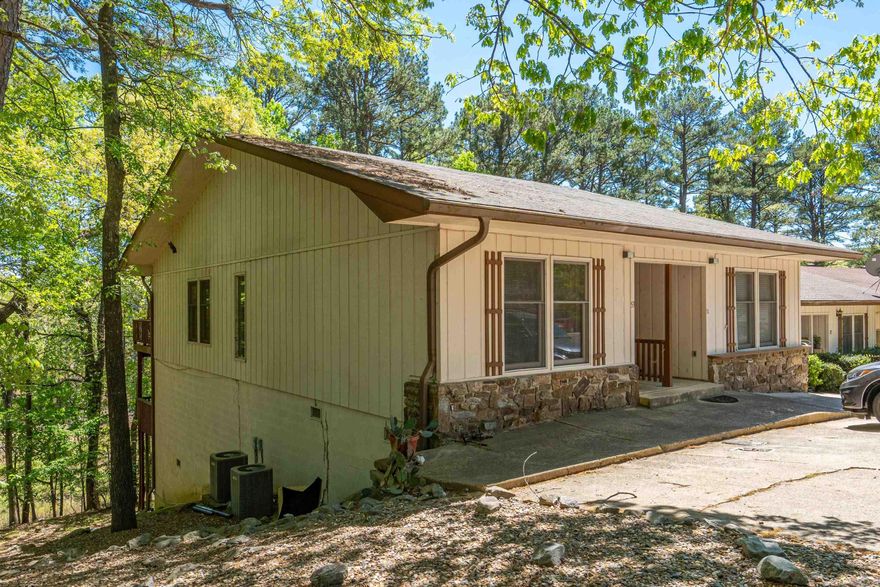 Updated end-unit townhome offering comfort, flexibility, and a peaceful wooded setting! This move-in ready 3-bedroom, 2 bath home features 1,402 sf across two levels, with a functional layout ideal for a variety of living situations.  The main level includes a spacious area that opens to a deck overlooking a private, wooded backyard-perfect for relaxing or entertaining. You'll also find a convenient main level bedroom and full bath, ideal for guest or single-level living needs. The lower level offers two additional bedrooms, a full bathroom and a laundry area, along with a versatile bonus room that can be used for storage, a hobby space, or flex room.  Enjoy added outdoor living with a second deck accessible from the lower-level bedroom.  Come and enjoy all that Hot Springs Village has to offer, including golf courses, lakes, tennis, pickleball, hiking trails and MORE!!! Call to see this great convenient fully furnished home ready for you to move in.