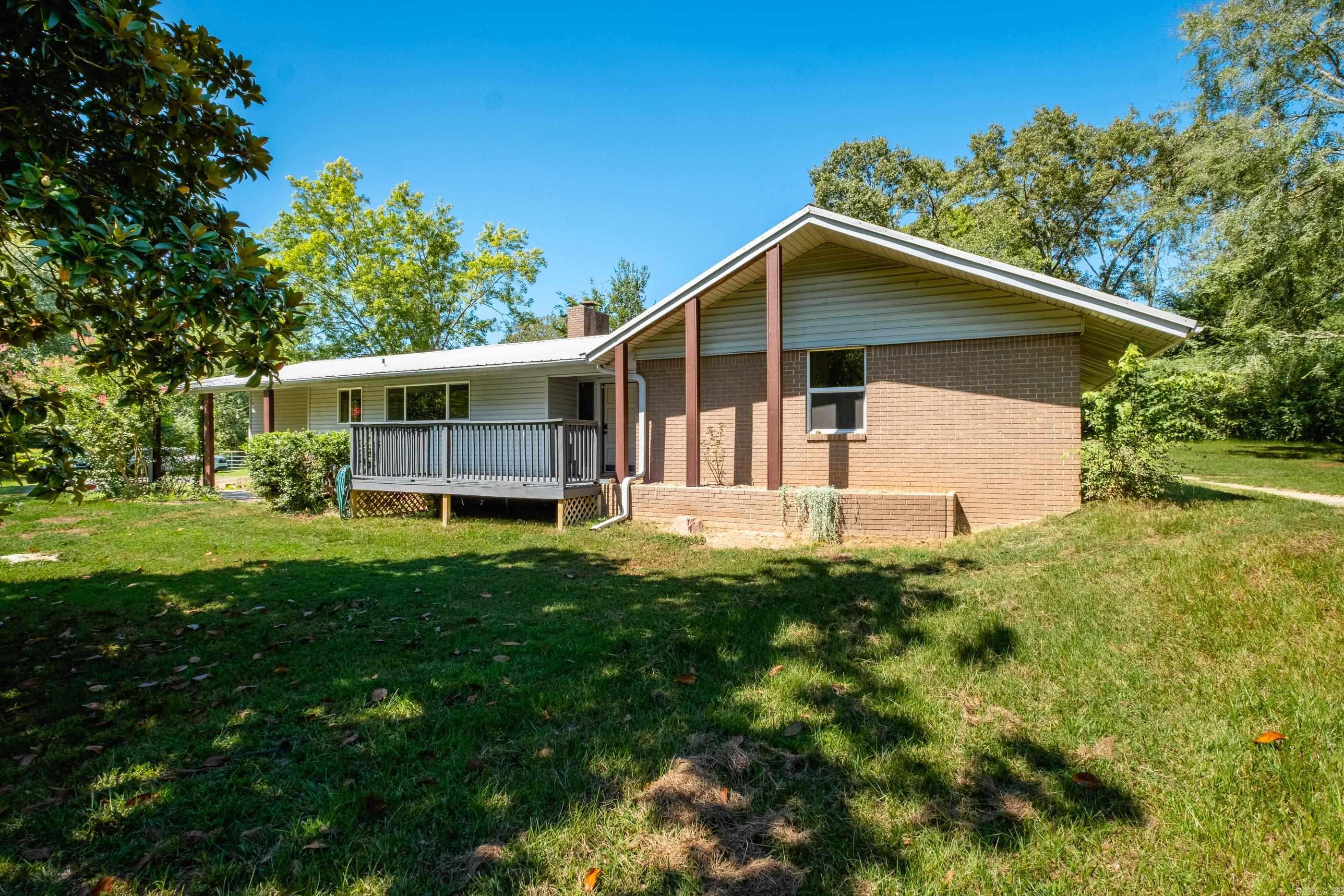 Updated one story home on almost 9 beautiful acres with a small pond, creek, and orchard of chestnut and hazelnut trees. Updates include WH 2020, cooktop 2022, dishwasher 2019, insulation 2023. New lighting and built-ins added. Home has a metal roof (2013). Property has RV hookups. Relax on the screened in porch and enjoy peaceful country living not far from Jacksonville and Sherwood/NLR amenities. Agents, see remarks.