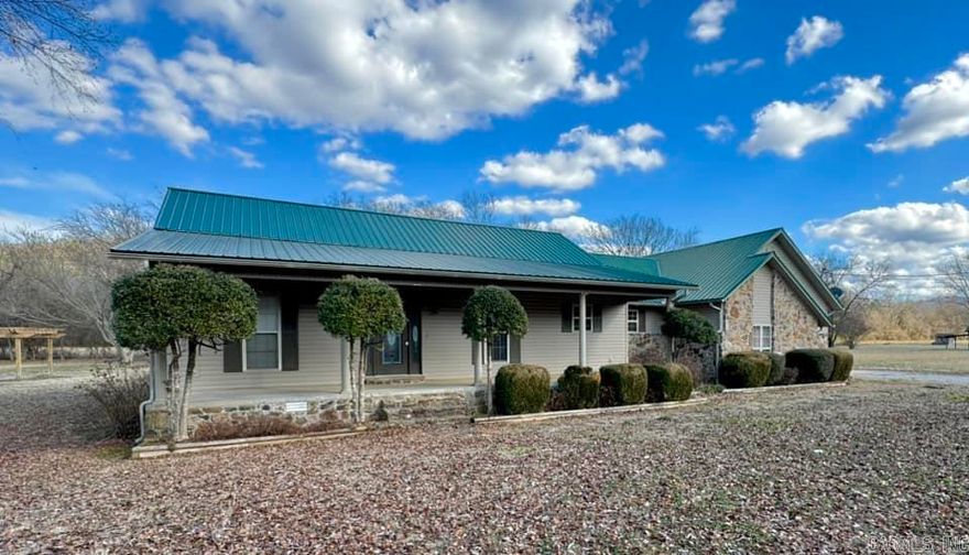 This charming 3 bedroom, 2 bath with the primary bedroom and bath separate from the 2 guest bedrooms. Open kitchen and dining room with a large, vaulted ceiling living room with a beautiful rock fireplace that leads out to a covered sun porch with mountain views all around. The kitchen offers ample cabinet space and a pantry which leads to large separate utility room and the 2-car attached garage for plenty of room for vehicles and storage.  Only a few miles from downtown Mtn View and just a walk across the road to the White River.