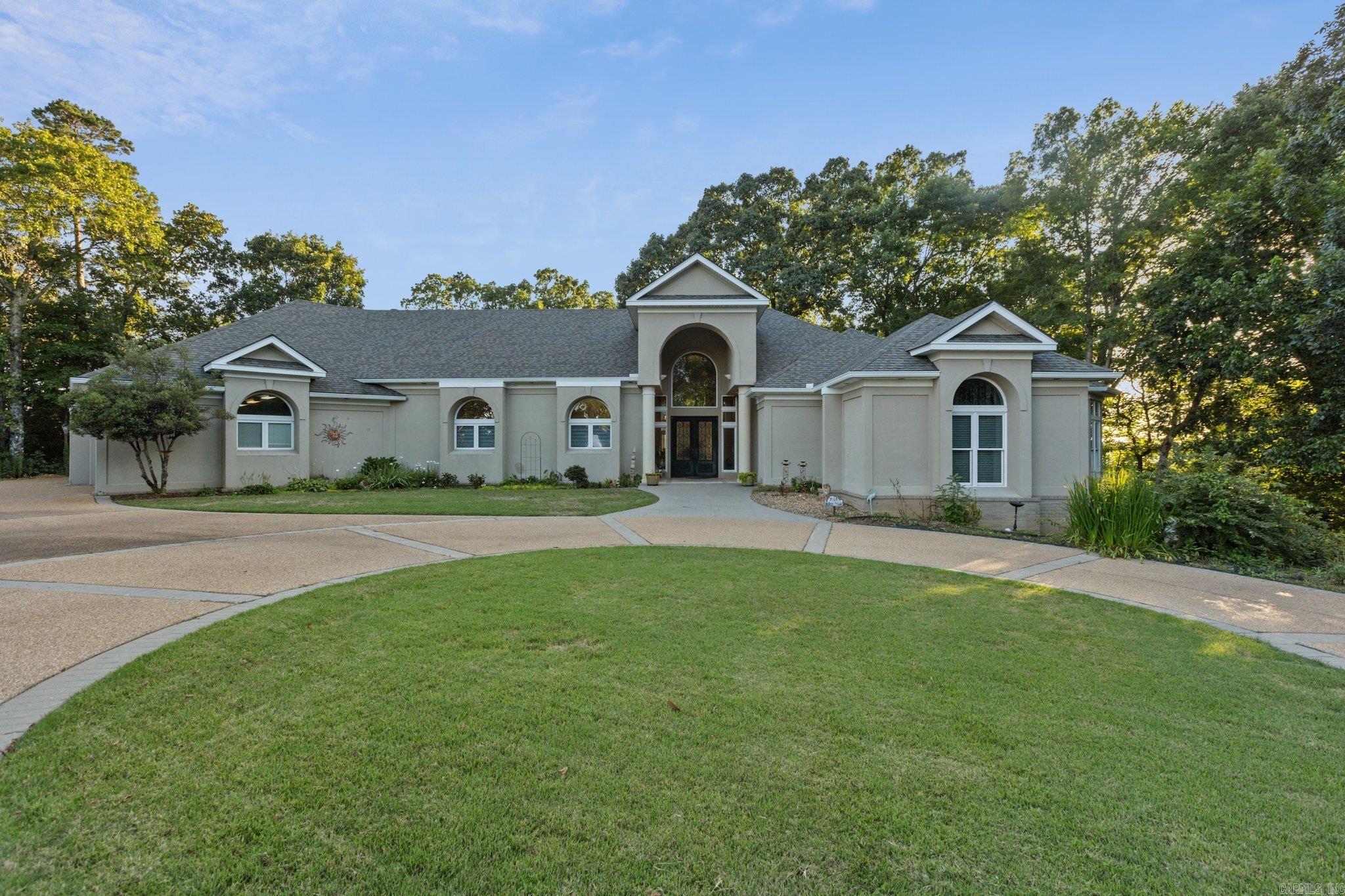 Stunning home in Benton, Arkansas. Offers the charm of an Ozark mountain top view with city conveniences. Twenty minutes from Little Rock and 38 minutes from Hot Springs. Provides easy access to a horse track, casino, fine dining, and a national forest. Short drive to Hot Springs Village offers access to 9 golf courses, 14 restaurants, and 11 lakes. Situated in gated community of River Oaks Point. Sits on a 2.5-acre lot at the end of a cul-de-sac, with views of the Saline River and Hot Springs National Forest. Featured in Active Years Magazine as āHome on the Hill,ā with a grand marble entry, 22-foot ceilings, and floor-to-ceiling windows. The butlerās kitchen includes custom cabinets, granite countertops, and high-end appliances. The south side features two rooms with a Jack-n-Jill bathroom, an outdoor kitchen, and a pool deck. A massive 5-car garage offers ample storage. The master suite includes a sitting area, bonus room, and luxurious bath with walk-in closets. Recent updates include refinished travertine floors, new carpet, an on-demand hot water heater, a whole-house generator, and a renovated pool deck. High ceilings, expansive windows. Backyard view is truly breathtaking!
