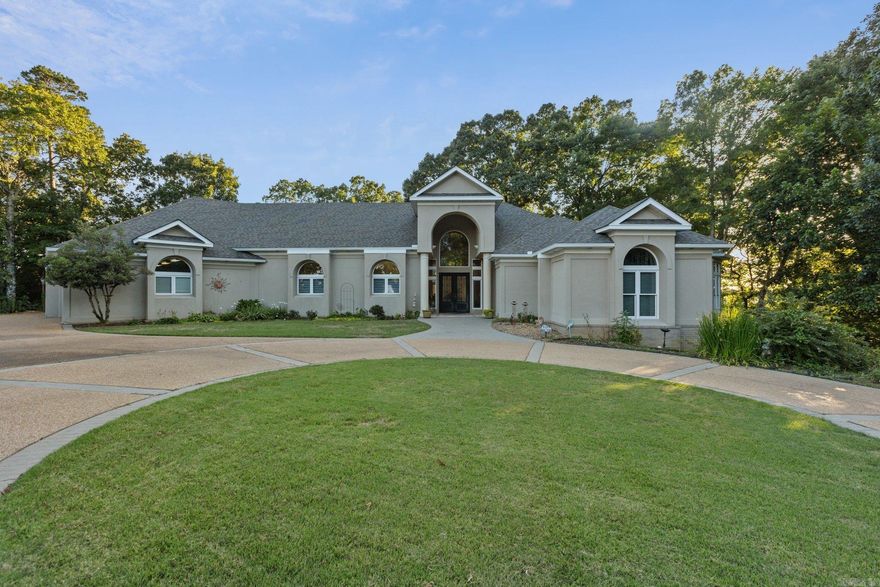 Stunning home in Benton, Arkansas. Offers the charm of an Ozark mountain top view with city conveniences. Twenty minutes from Little Rock and 38 minutes from Hot Springs. Provides easy access to a horse track, casino, fine dining, and a national forest. Short drive to Hot Springs Village offers access to 9 golf courses, 14 restaurants, and 11 lakes. Situated in gated community of River Oaks Point. Sits on a 2.5-acre lot at the end of a cul-de-sac, with views of the Saline River and Hot Springs National Forest. Featured in Active Years Magazine as “Home on the Hill,” with a grand marble entry, 22-foot ceilings, and floor-to-ceiling windows. The butler’s kitchen includes custom cabinets, granite countertops, and high-end appliances. The south side features two rooms with a Jack-n-Jill bathroom, an outdoor kitchen, and a pool deck. A massive 5-car garage offers ample storage. The master suite includes a sitting area, bonus room, and luxurious bath with walk-in closets. Recent updates include refinished travertine floors, new carpet, an on-demand hot water heater, a whole-house generator, and a renovated pool deck. High ceilings, expansive windows. Backyard view is truly breathtaking!