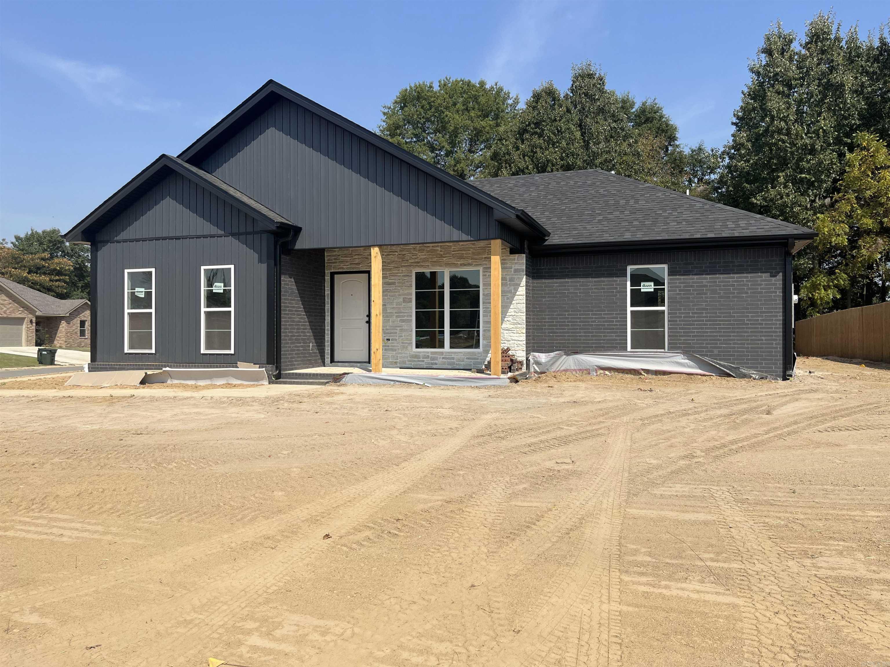 Stunning New Construction in Ridgepark Subdivision! Discover your dream home in this beautifully designed modern residence featuring sleek black brick on a desirable corner lot. This 3-bedroom, 2-bathroom gem offers a seamless blend of style and functionality. Step inside to find a spacious layout that includes a convenient separate laundry room and a welcoming drop zone right off the garage, perfect for keeping your home organized. The master suite is a true retreat, boasting a generous walk-in closet and a luxurious en-suite bath complete with double sinks, a tiled shower/relaxing soaker tub. Enjoy your morning coffee or evening gatherings on the covered back porch, while gas heating ensures cozy comfort year-round. With a spacious 2-car garage, you'll have room for all your toys. Don't miss out on this exceptional opportunity to call Ridgepark home schedule your tour today!