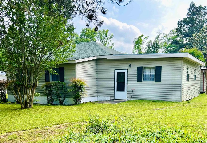 Neat and Affordable on a beautiful 1 acre property in Hampton!  With 1249 sq ft of living space, this 2 Bedroom, 1 Bath home would be a great starter or step down property! Located in the Woodberry community of Hampton, this home offers a roomy interior and abundance of storage space. There is a large shop (with the possibility of restoring plumbing lines), a small outbuilding, and a wonderful covered back porch. If self-reliance is what you are looking for- there is a spring water well on the property that has been used in previous years- and the land would be ideal for gardening. This home is an older property but has had many improvements. The roofs on both the house and shop were replaced approximately 3-4 years ago, the septic system and field lines were completely replaced about 8 years ago, and the interior has had foundation repairs and new lvp added over the last 5 years. In 2026, new foundation skirting was installed. Don't miss this affordable property!