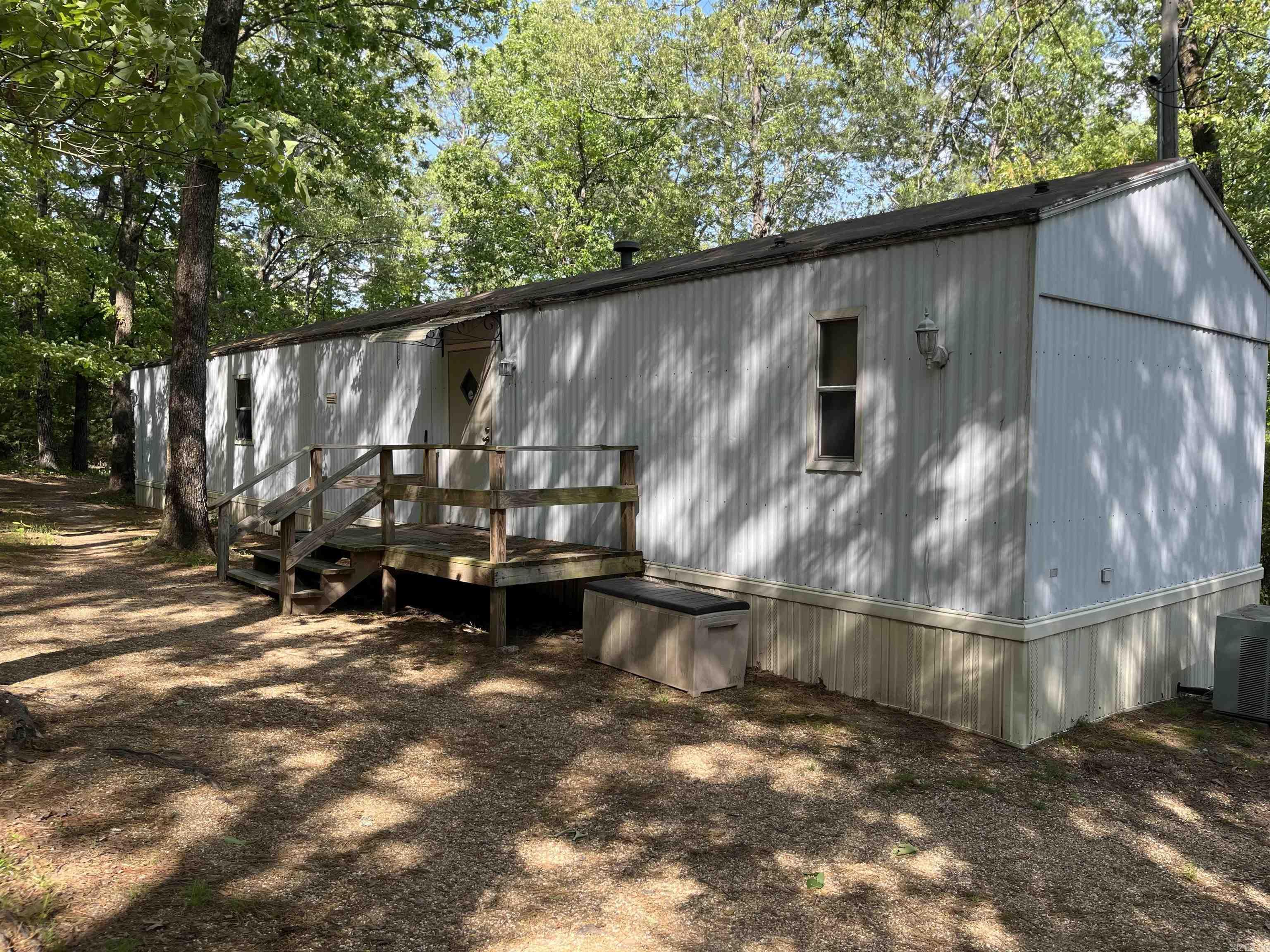 Well maintained single wide mobile home on 1.32 acres +/-. Beautiful wooded lot with seasonal lake view of Greers Ferry Lake. Two bedroom/ two bath home with large living area and kitchen. All appliances convey plus a stackable washer/dryer. All you need is to bring your boat or lake toys and you're ready for a weekend retreat. Boat launch just around the corner and walking distance to Choctaw Recreation area and Greers Ferry Lake. Acreage could be subdivided into smaller lots. No restrictions! Hospital facilities and shopping are 10 minutes away. Everything you need is right here. Bring your campers, bring the family and start enjoying the Lake Life!