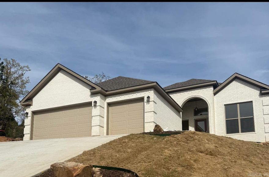 This gorgeous new-construction home in Maumelle’s prestigious Majestic Pointe subdivision offers the perfect blend of luxury, comfort, and thoughtful design. Enjoy stunning views of Pinnacle Mountain from the formal dining room, then step into the open-concept living area featuring a warm gas-log fireplace and a chef’s kitchen with quartz countertops, stainless steel appliances, abundant cabinetry, pantry, and an oversized island with breakfast bar. The primary suite is a true retreat, complete with a spa-like bathroom boasting double vanities, a custom-tiled walk-in shower, a soaking tub, and dual walk-in closets. Three additional bedrooms share a full bath, and the home includes a dedicated laundry room. High-end trim work and luxury vinyl plank flooring run throughout. With a 3-car garage, floored attic storage, and a covered patio overlooking the backyard, this home delivers exceptional value and style. Don’t miss your chance to make it yours. See agent remarks