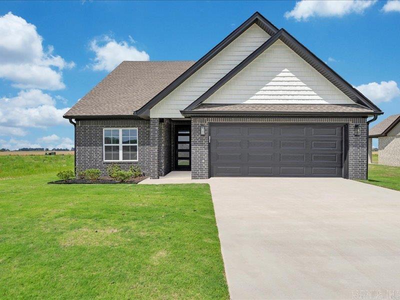 This brand-new, three-bedroom, two-bath home offers a stunning open-concept design, perfect for modern living. As you step inside, you'll be greeted by an airy, light-filled space with sleek contemporary features throughout. The spacious living area flows seamlessly into the dining and kitchen spaces, creating an ideal setting for both everyday life and entertaining. The kitchen is a true showstopper, featuring bold black cabinets that contrast beautifully with the bright white paint and pristine white granite countertops. The modern finishes and thoughtful design create a fresh, sophisticated atmosphere. High-end appliances and plenty of storage make this kitchen both stylish and functional. The open floor plan extends into the living and dining areas, which are spacious and filled with natural light, enhancing the home's welcoming vibe. Each of the three bedrooms offers ample space, with large windows that bring in plenty of sunshine. The bathrooms are equally impressive, with contemporary fixtures and finishes that complement the home's overall design.