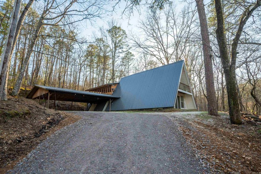 Fantastic opportunity for Investors!!!  A-Frame with New Roof, A Perfect remodeling project with lots of possibilities as it has has great bones. Ideal for Airbnb with plenty of acreage for additional Cabins or more A-Frames. House has nice Natural stone floor, screened in porch and fenced back yard. Very nice Rock Fireplace Pit type base ready for completion. 3 Car Carport.  Priced to sell! Won't last long!!