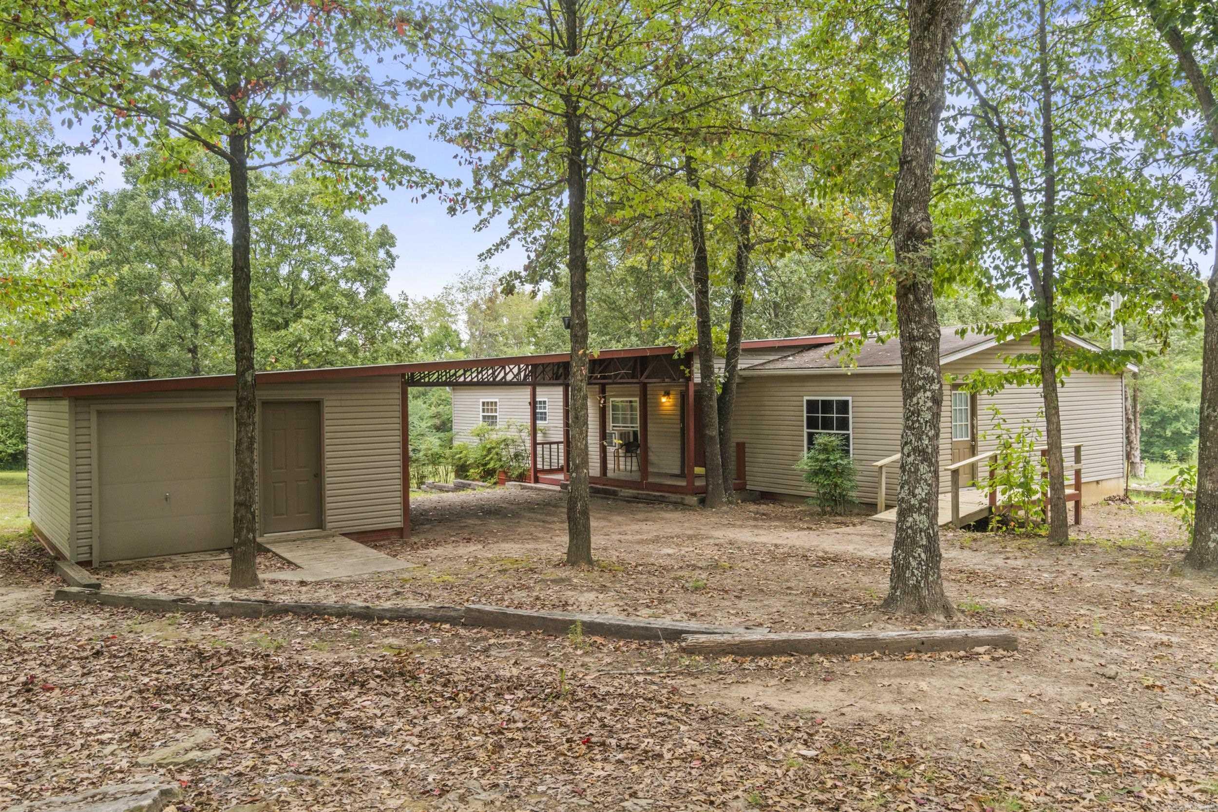 Gorgeous land with large, mature trees and endless potential. The main home is a spacious mobile with a split floor plan, while the second home is a stick-built residence that was completely remodeled just a few years ago. A workshop is also included, making this property ideal for a variety of uses.