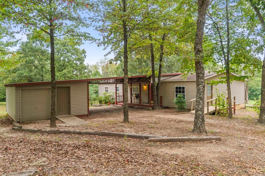 Gorgeous land with large, mature trees and endless potential. The main home is a spacious mobile with a split floor plan, while the second home is a stick-built residence that was completely remodeled just a few years ago. A workshop is also included, making this property ideal for a variety of uses. Per tax records, main house (3 BR / 2 BA) is 1508 sq ft and guest house (2BR / 1 BA) is 1152 sq ft.