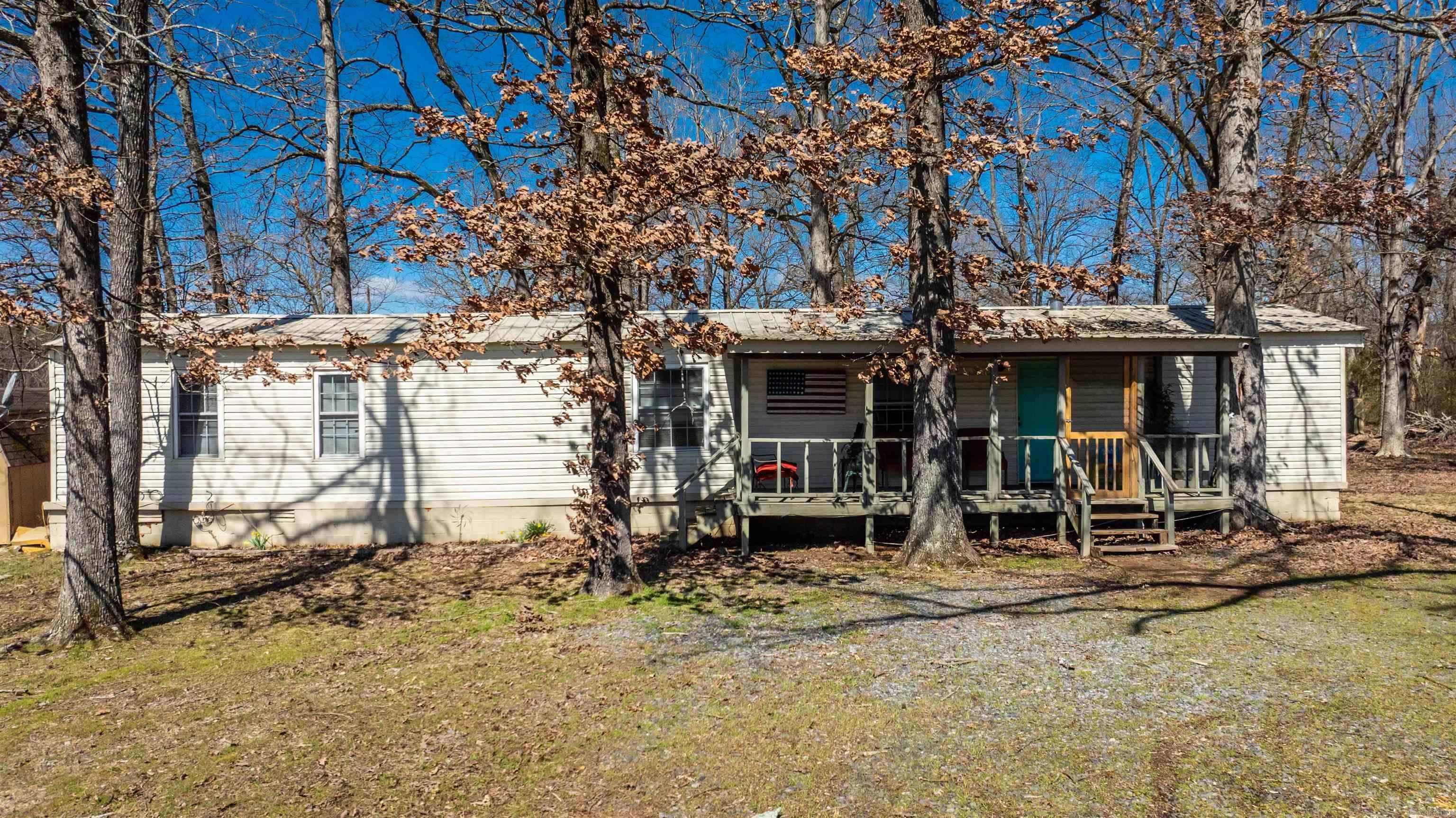 Waterfront home featuring STUNNING panoramic VIEWS of Lake Conway! This cozy home offers 2 bedrooms, 2 bathrooms, and a desirable open concept and split floorplan. Wake up in the mornings with views of the lake from your bedroom and enjoy quiet mornings & evenings with views of the lake from your front porch. Kitchen refrigerator, washer and dryer and outside storage building included. Won’t last long! Schedule a tour today! Agents see remarks.
