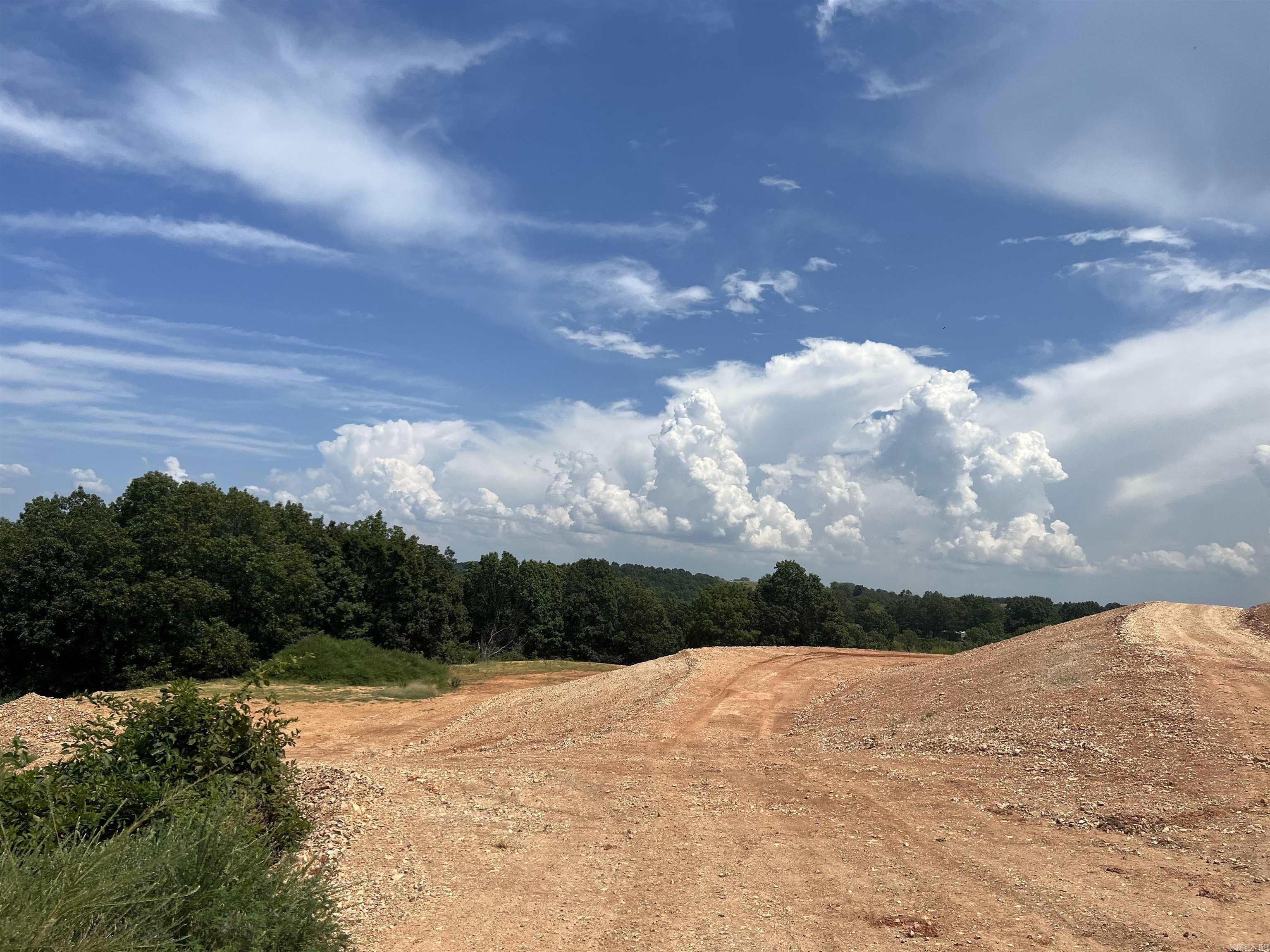 Property has been prepped with 2 large level spots ready to build a home and shop on 5 acres m/l. The electric poles are running along the road. No restrictions. This is a must see country property.