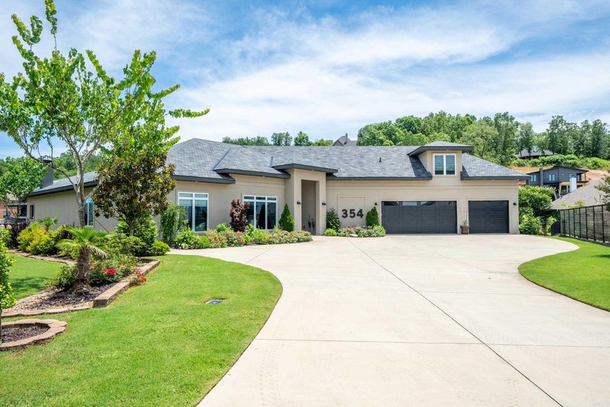 Top of the line custom built home on Lake Hamilton in Hot Springs. Great for entertaining inside and out. Beautiful concrete flooring. Open floor plan. Outdoor kitchen has ice machine, grill, kegerator, woodburning fireplace, island, and dishwasher. Conveniently located in gated community. This home is a must see. Three bedrooms down and one large upstairs with its own bath for your guest's privacy. Whole house generator conveys.